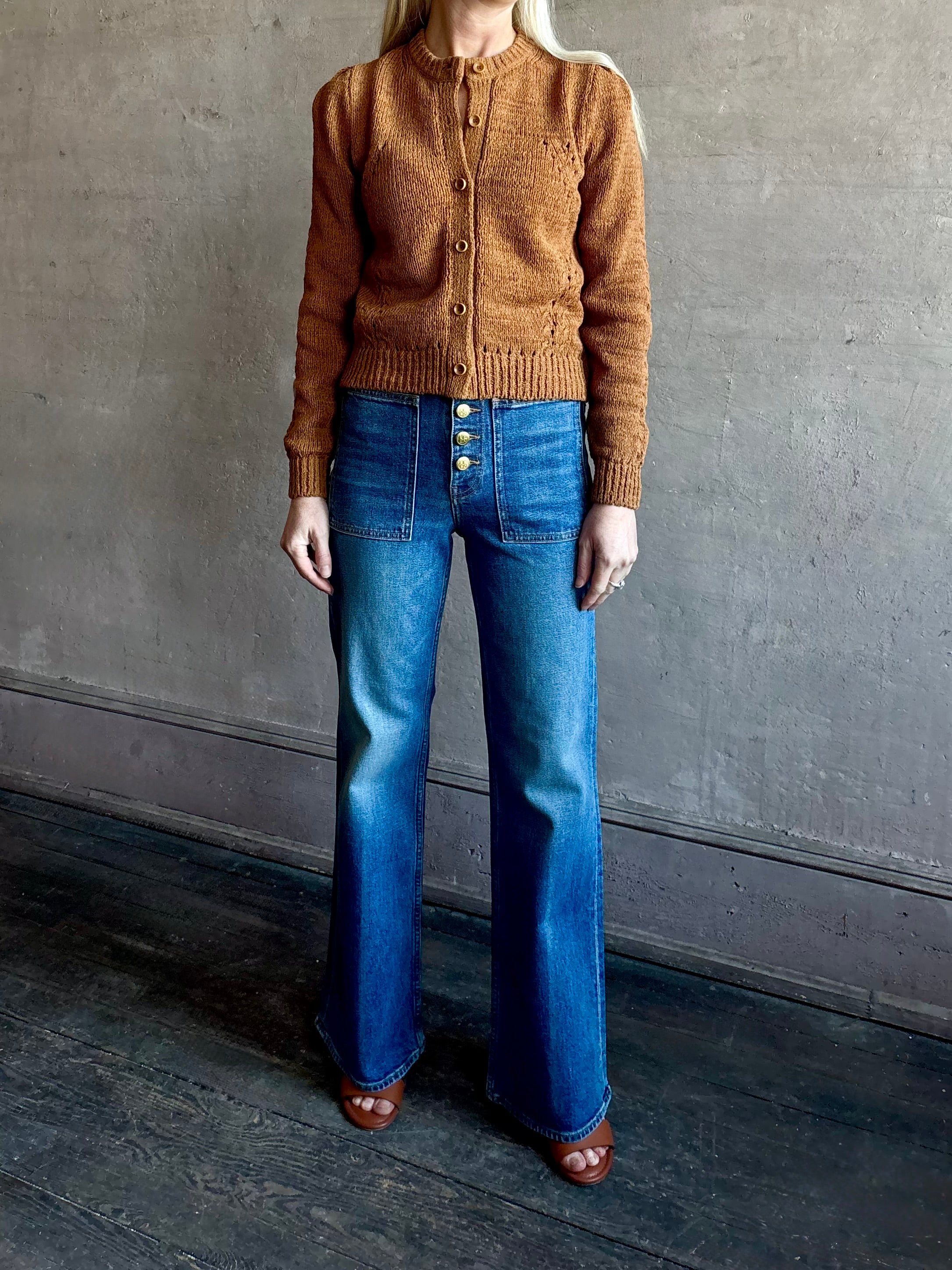 Woman wearing women's designer denim the Lou Jean from Ulla Johnson handcrafted in USA with gold buttons, front pockets and straight legs in medium wash denim