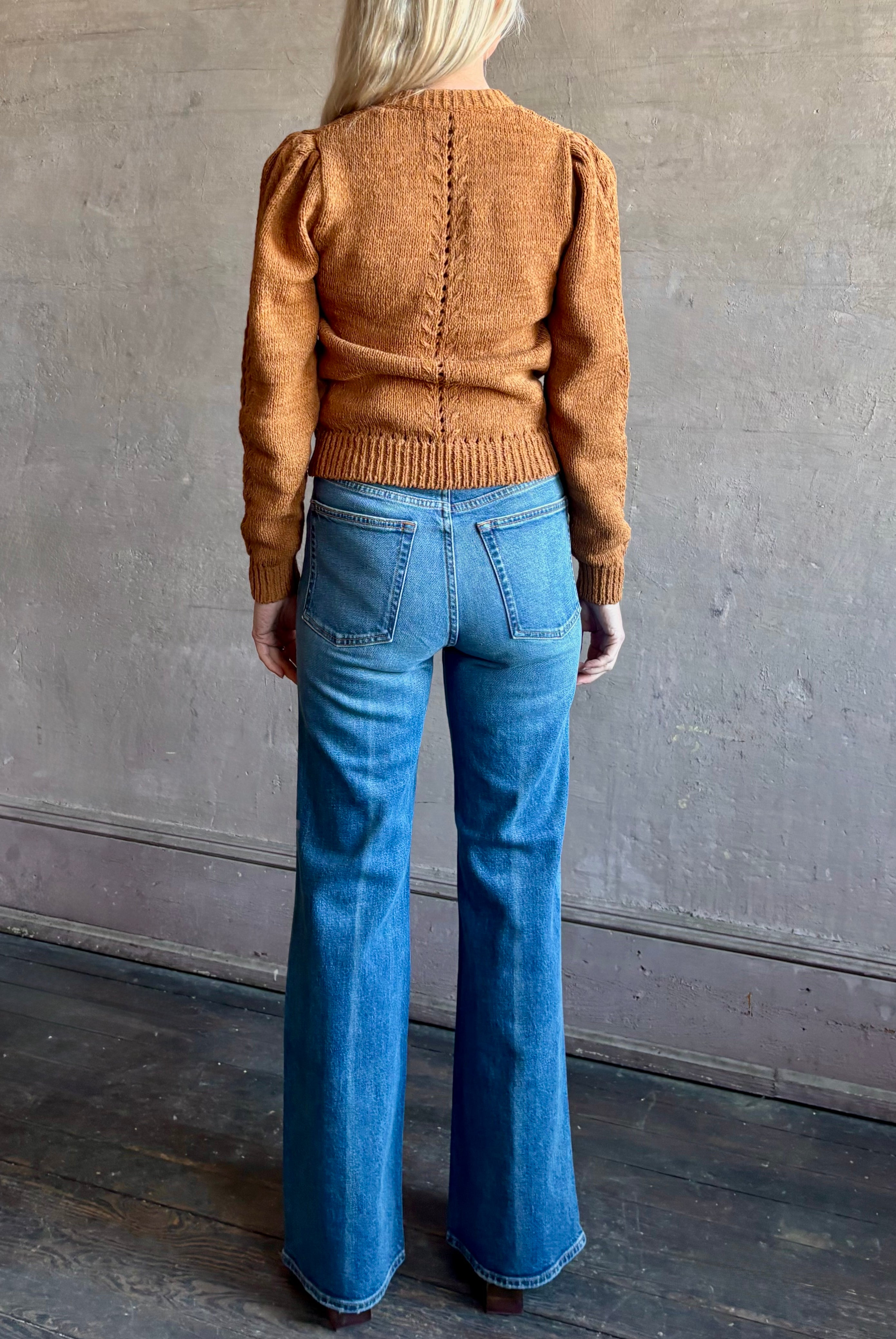 Woman wearing women's designer denim handcrafted in USA, the Lou Jean from Ulla Johnson with back pockets and straight legs in medium wash denim