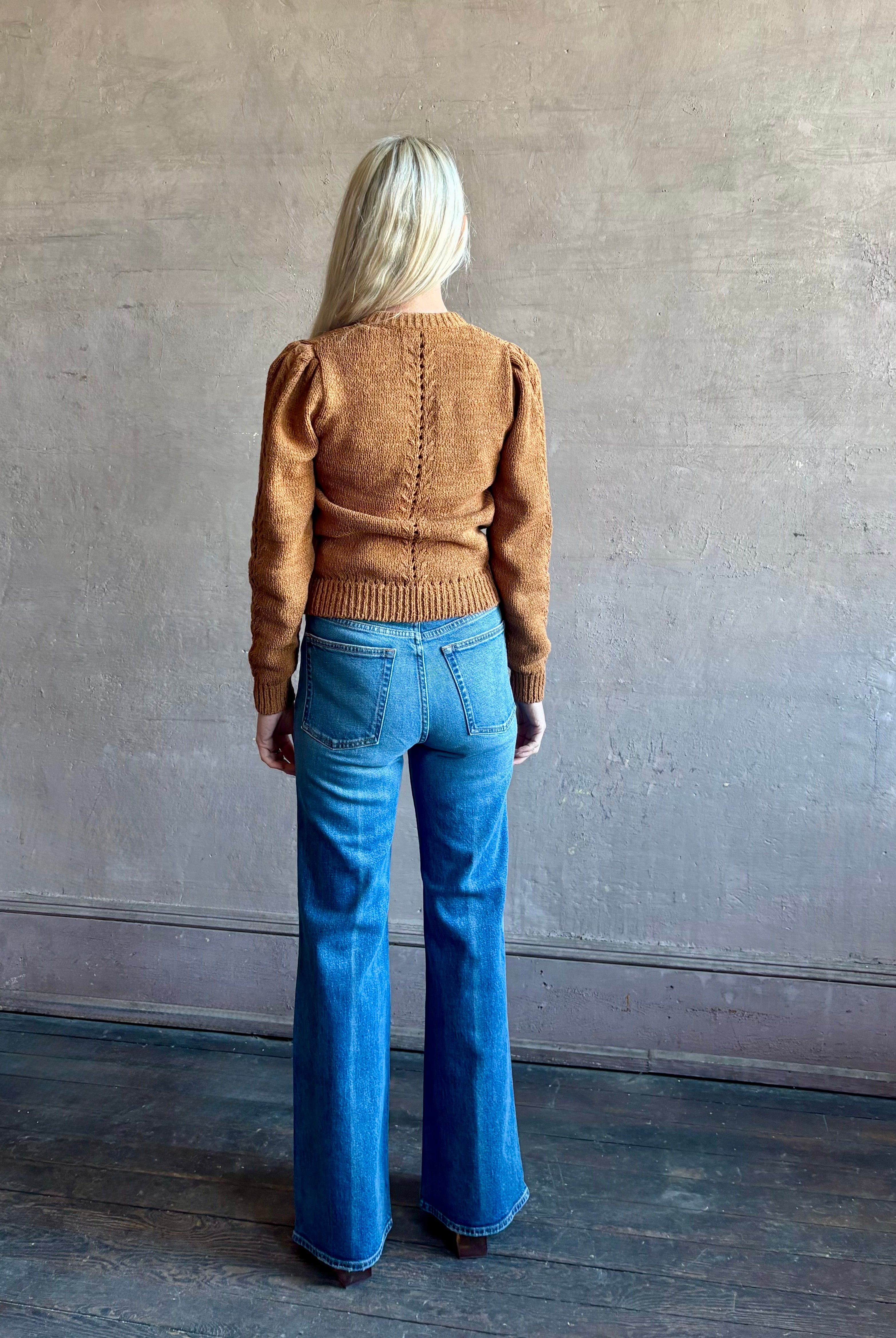 Woman wearing women's designer denim the Lou Jean from Ulla Johnson handcrafted in USA with gold buttons, front pockets and straight legs in medium wash denim