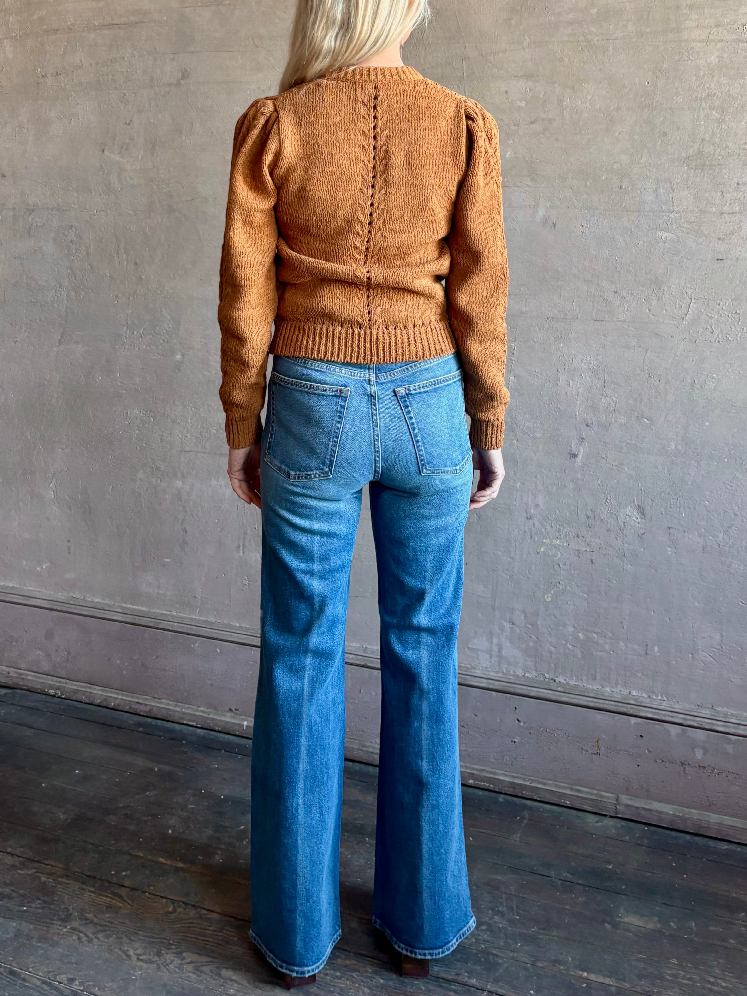 Woman wearing women's designer denim handcrafted in USA, the Lou Jean from Ulla Johnson with back pockets and straight legs in medium wash denim