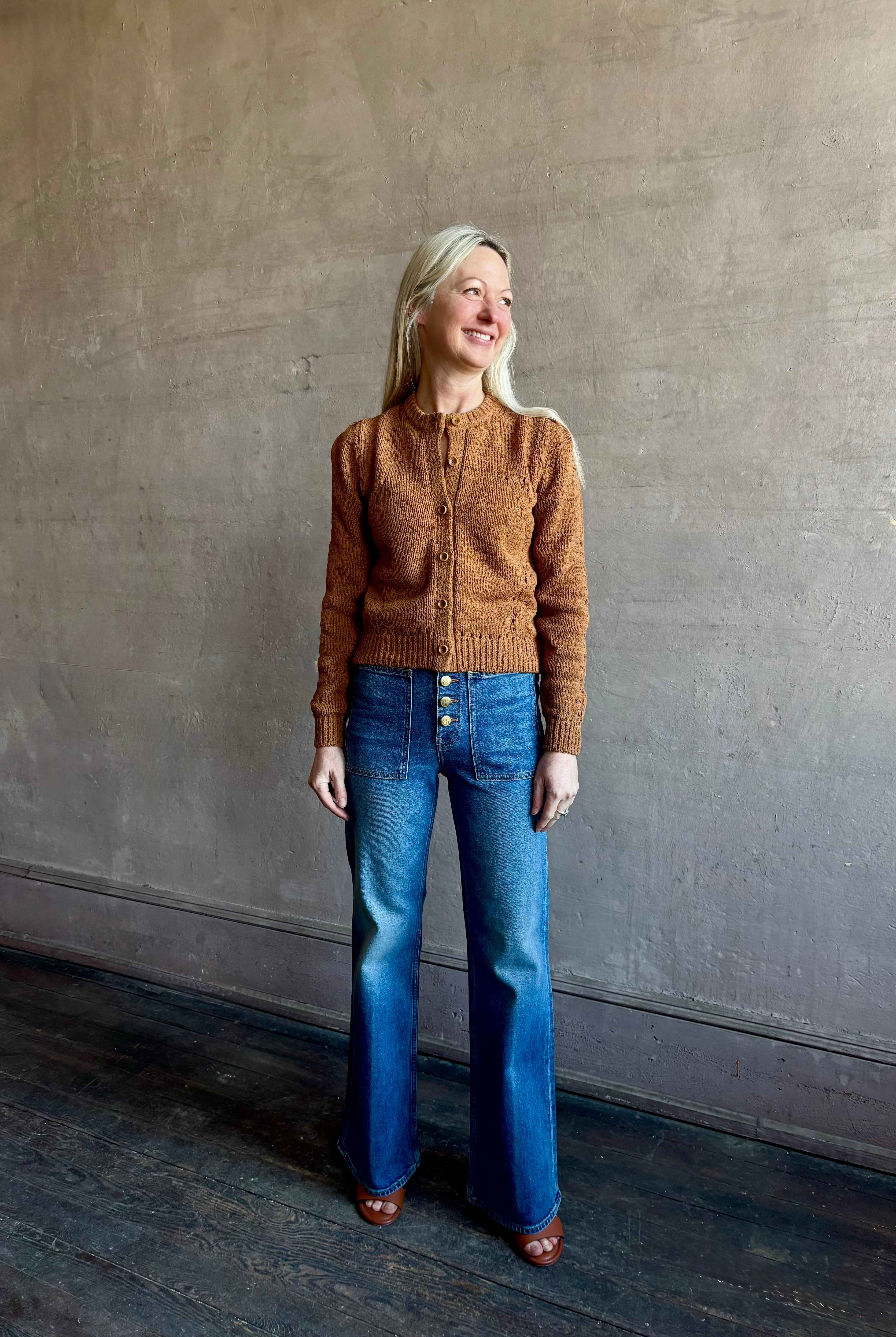 Woman wearing women's designer denim the Lou Jean from Ulla Johnson handcrafted in USA with gold buttons, front pockets and straight legs in medium wash denim