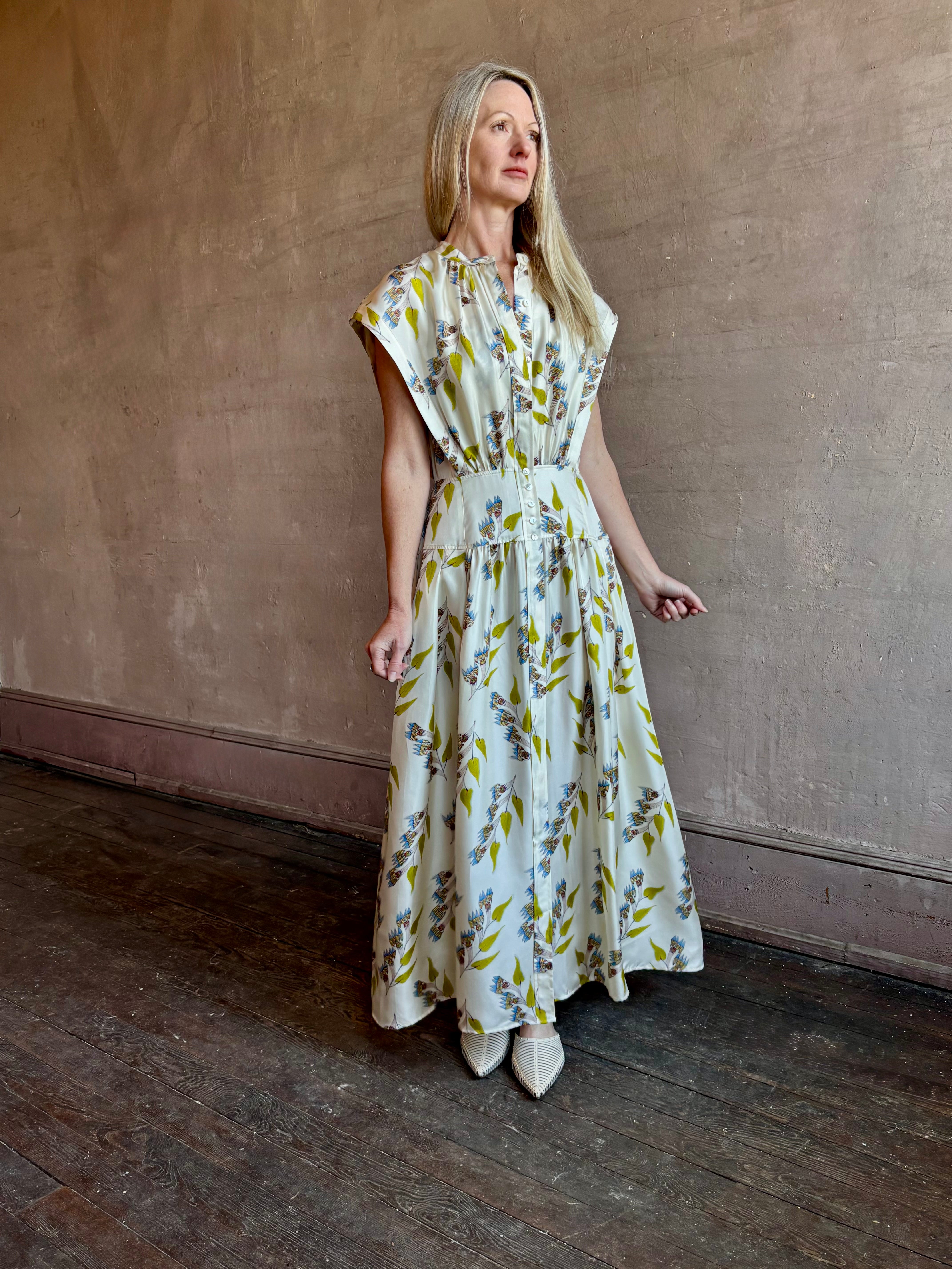 Image of woman wearing limited edition ULLA JOHNSON Lausanne silk occasion dress with pockets in sophisticated floral pattern by painter Anna Zemankova