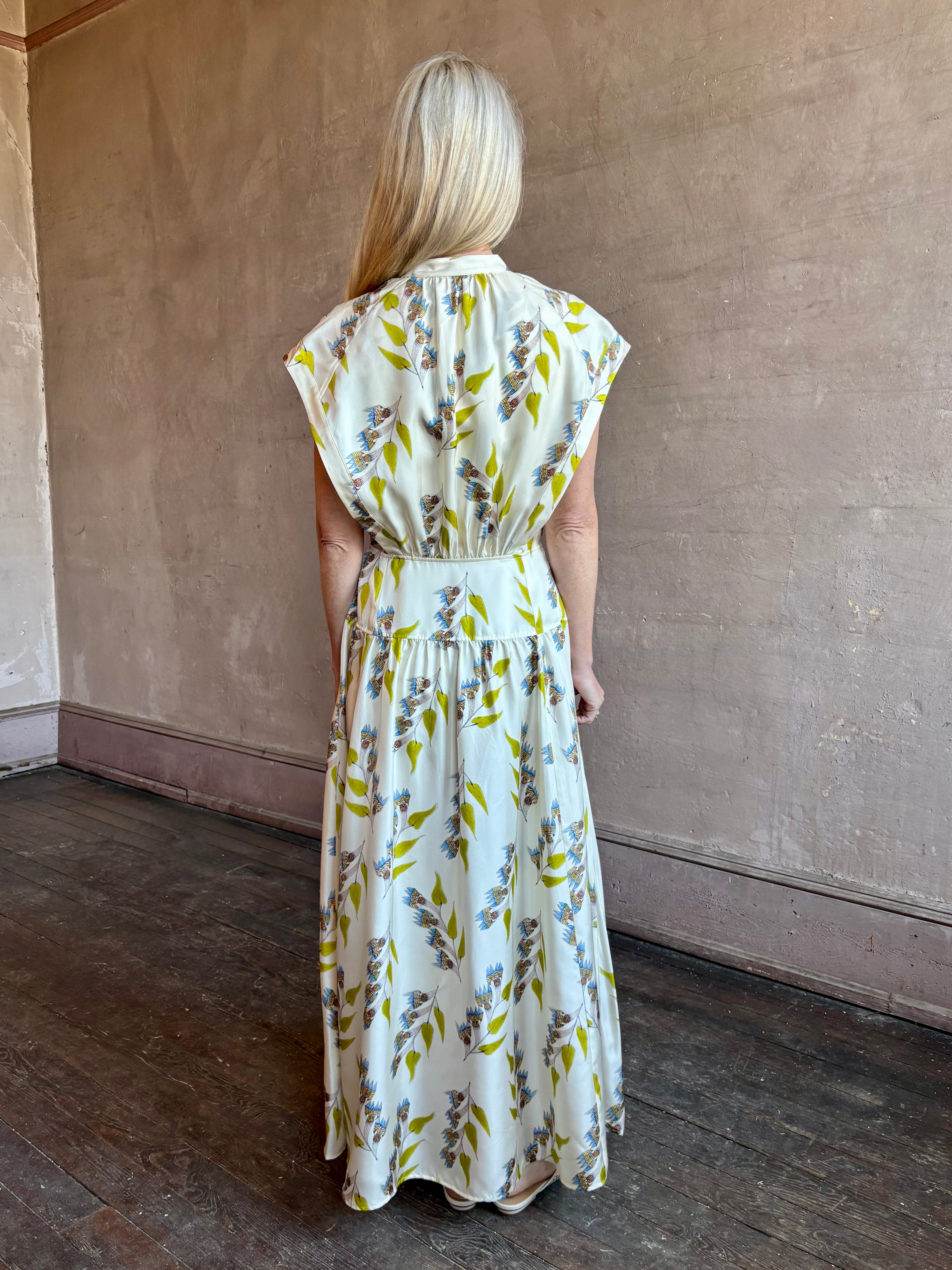 Image of woman wearing limited edition ULLA JOHNSON Lausanne silk occasion dress with pockets in sophisticated floral pattern by painter Anna Zemankova
