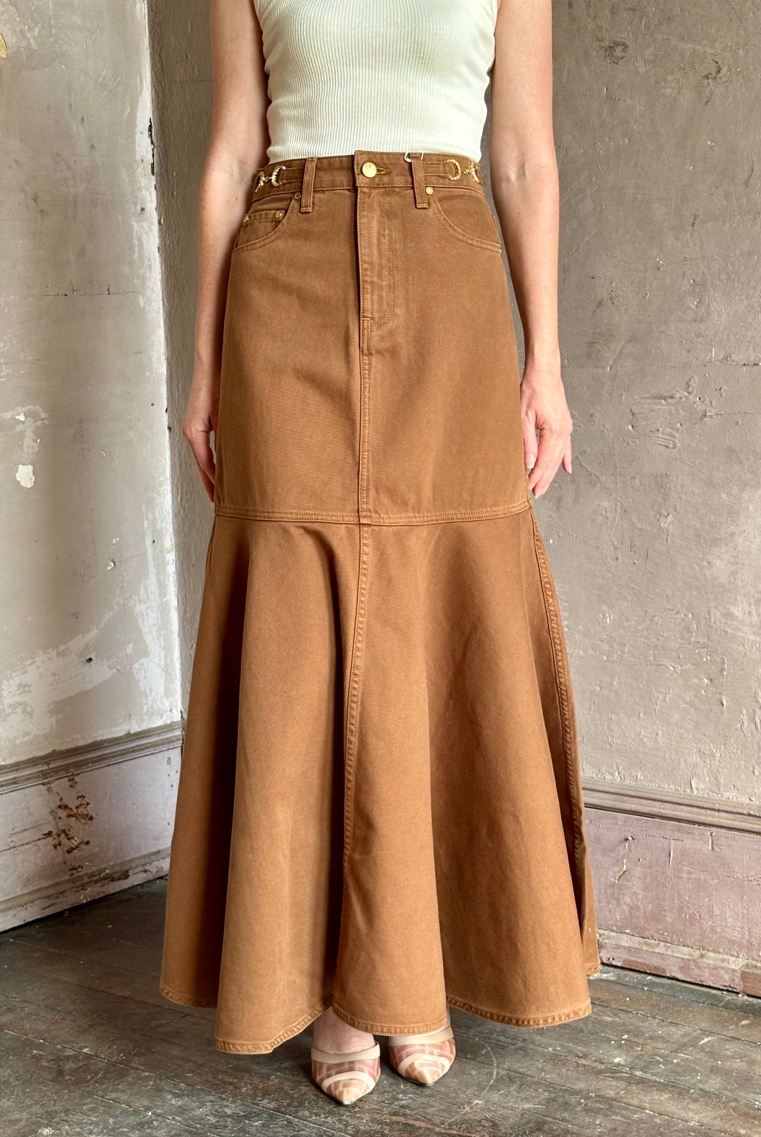 Mature woman wearing elevated designer Ulla Johnson Madelyn cotton denim mermaid skirt made in USA
