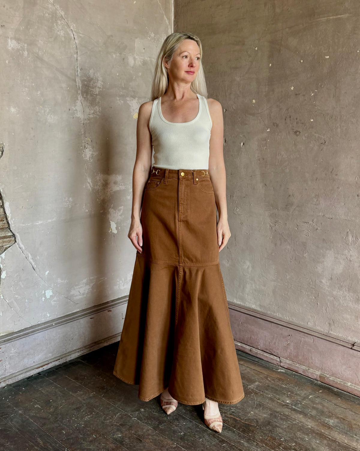 Mature woman wearing designer Ulla Johnson sculptural Madelyn cotton denim skirt made in USA