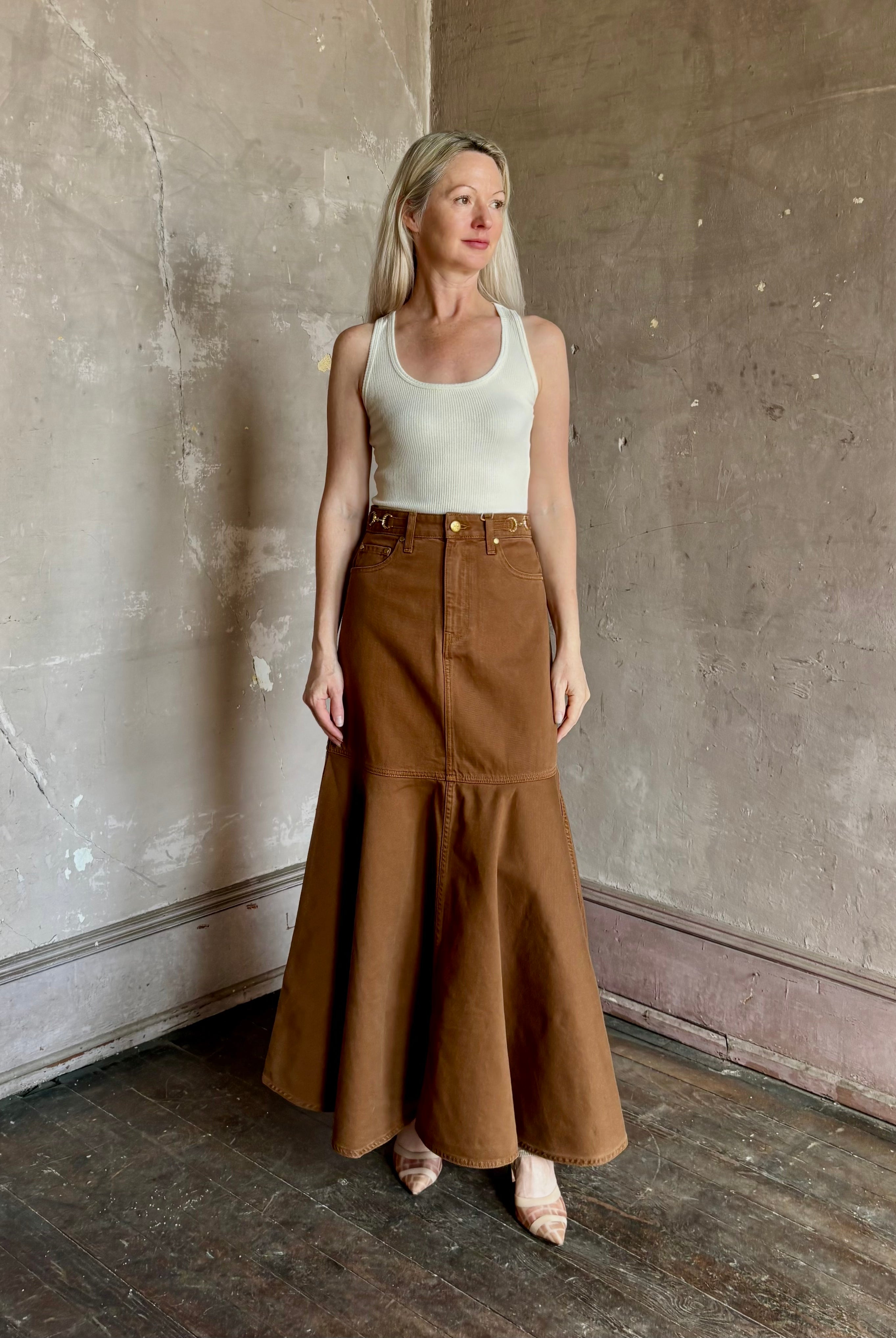 Mature woman wearing designer Ulla Johnson sculptural Madelyn cotton denim skirt made in USA