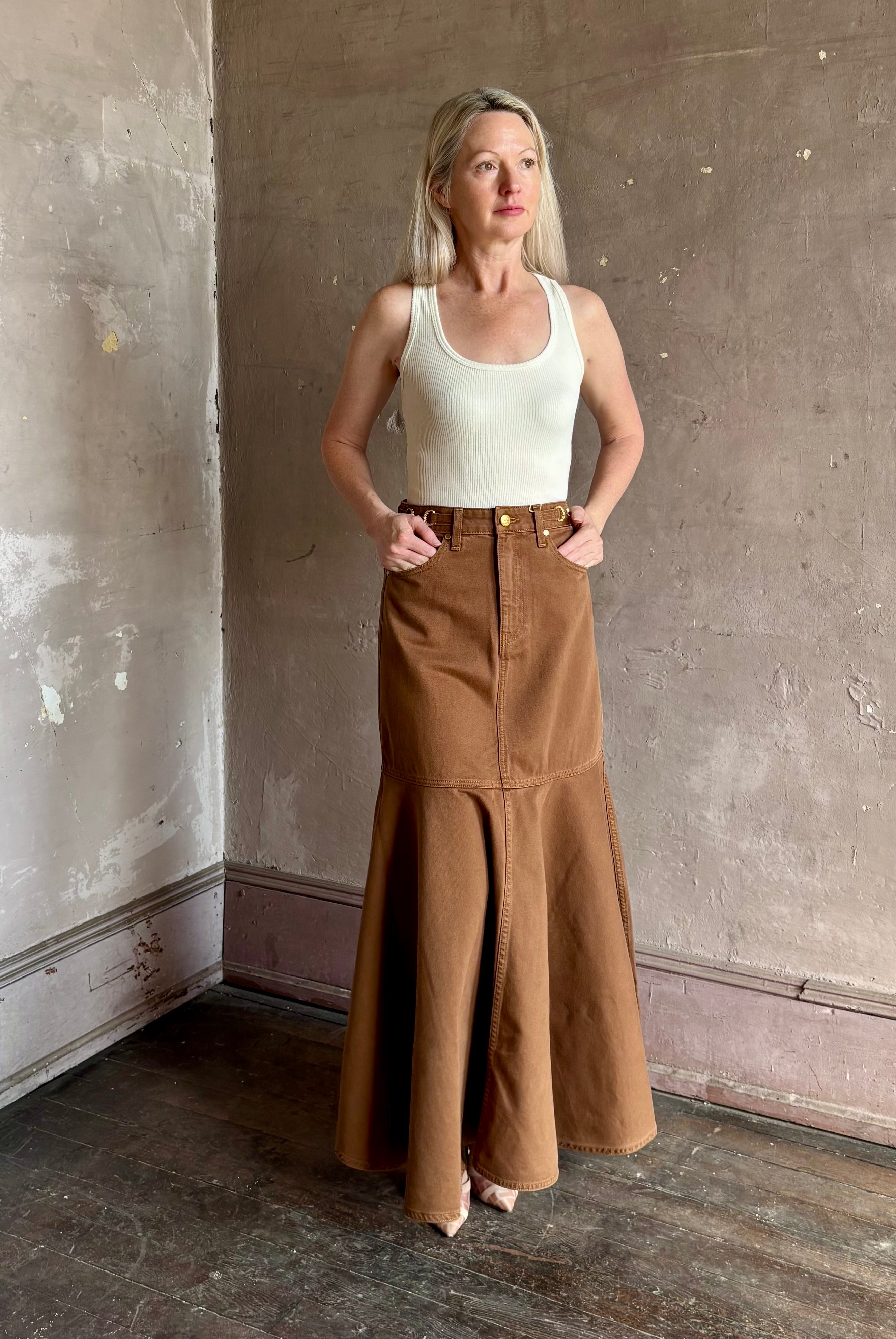 Mature woman wearing elevated designer Ulla Johnson Madelyn cotton denim skirt made in USA