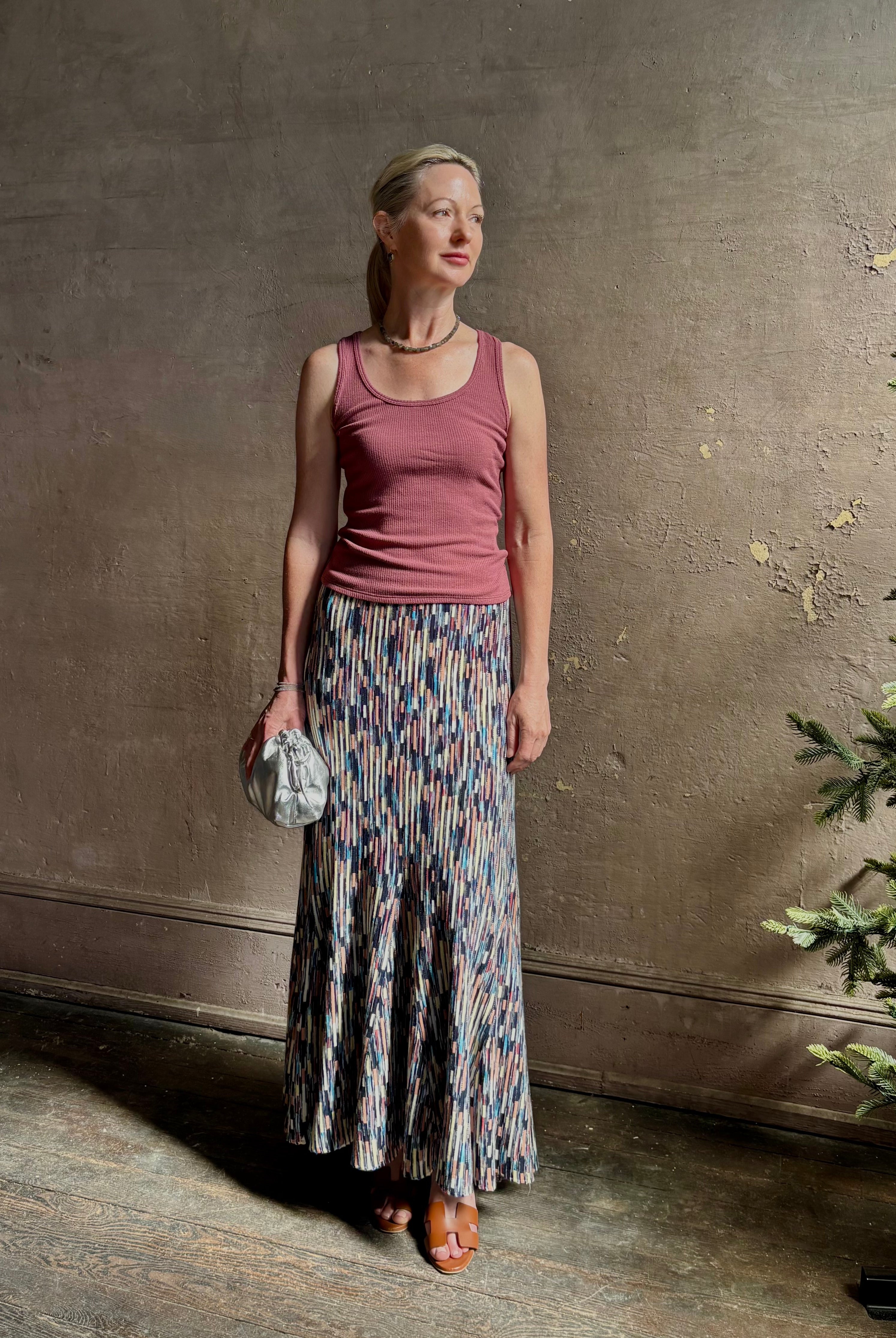 Mature woman wearing Ulla Johnson Marceline maxi knit cotton Skirt Oasis colorway navy, aqua, and terra cotta
