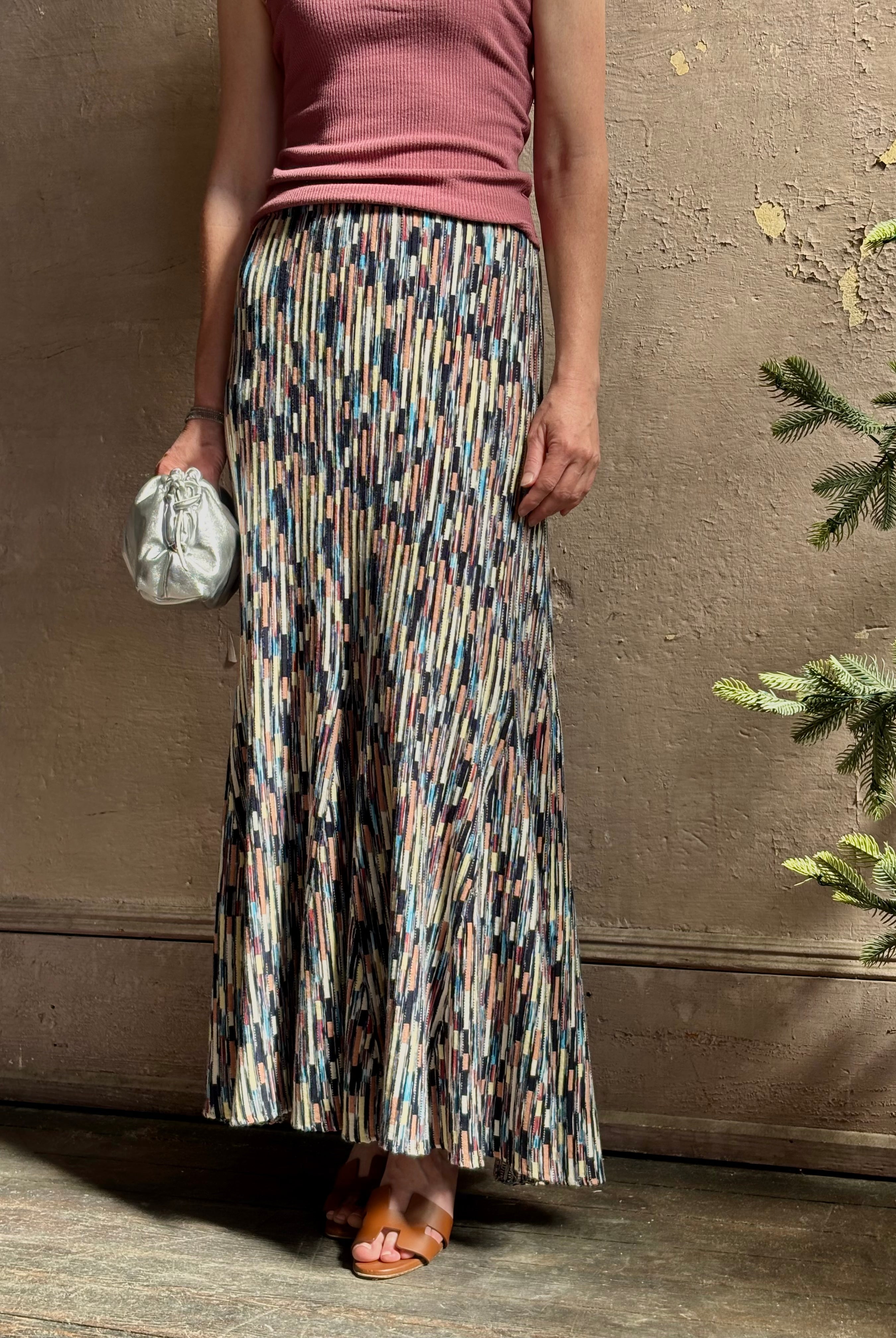 Mature woman wearing Ulla Johnson Marceline maxi knit cotton Skirt Oasis colorway navy, aqua, and terra cotta