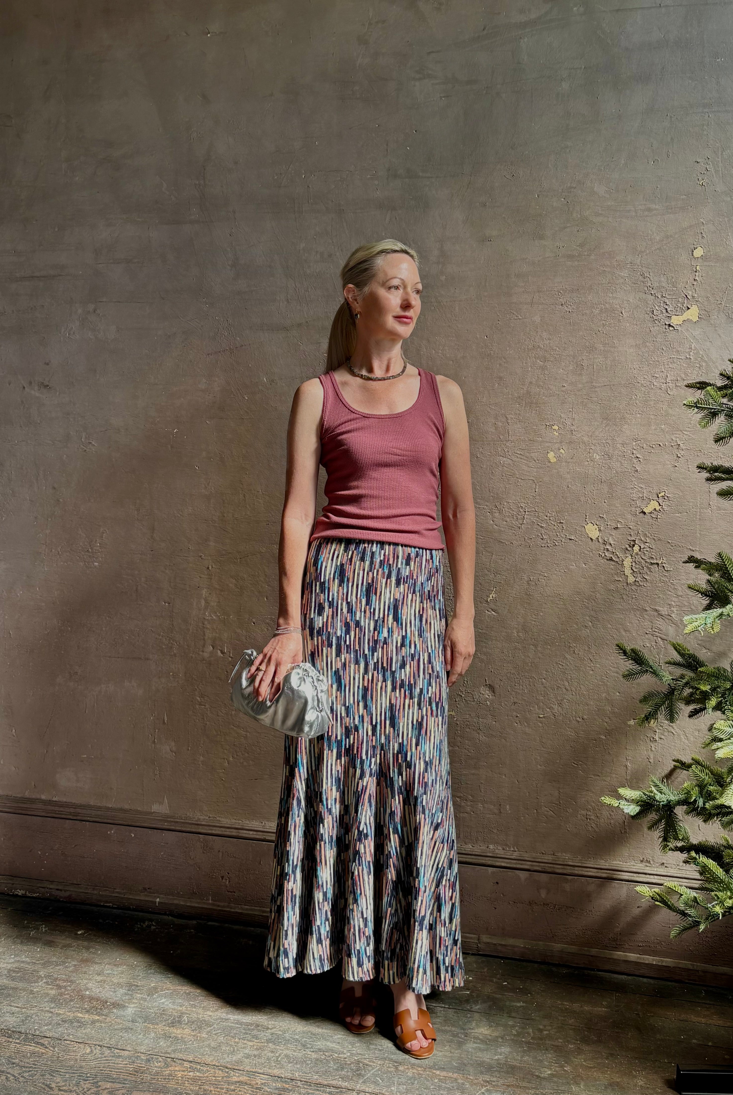 Mature woman wearing Ulla Johnson Marceline maxi knit cotton Skirt Oasis colorway navy, cream, peach, yellow,