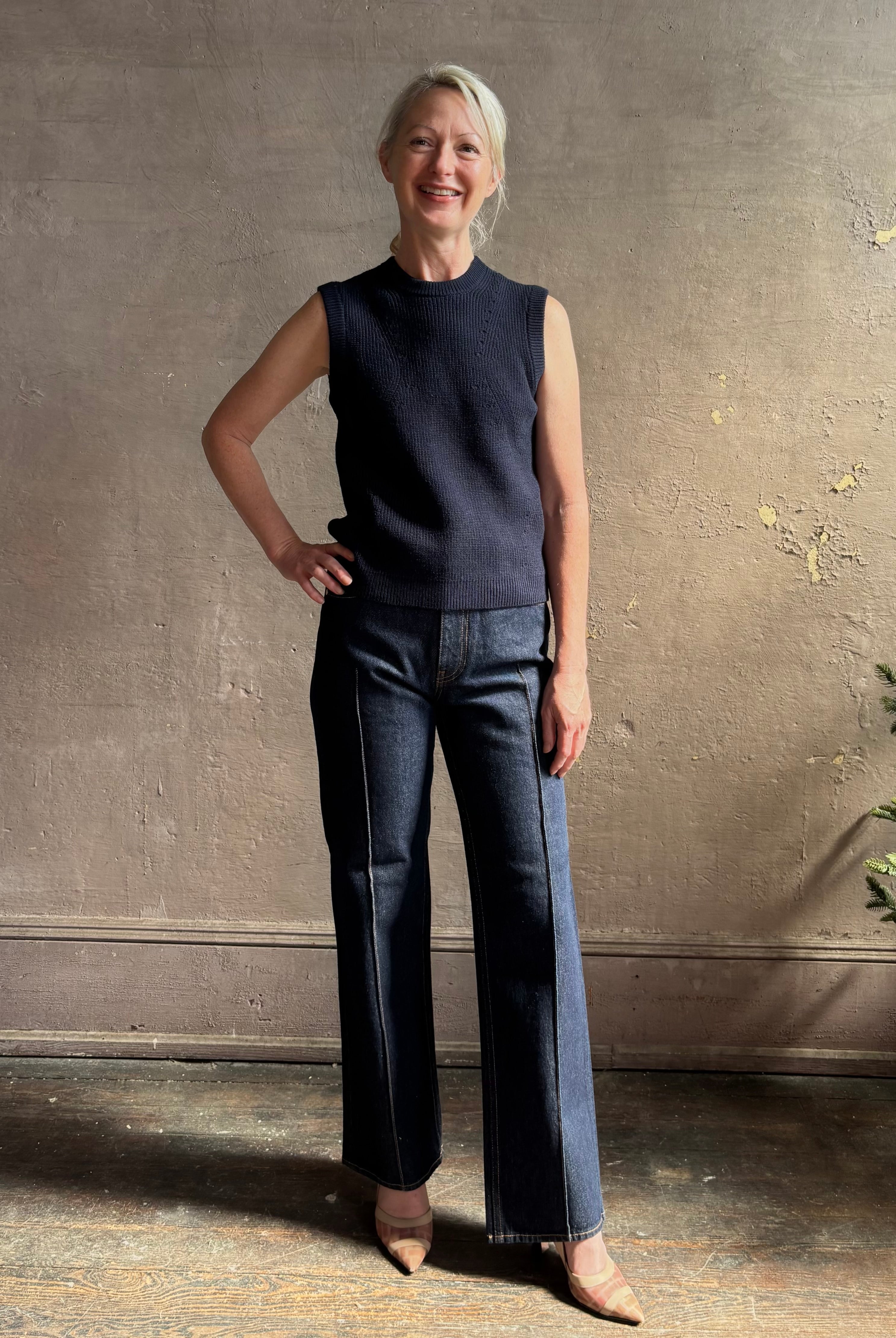 Mature woman wearing designer Margot sleeveless Knit Top from Ulla Johnson rendered in a rich midnight blue and knitted from 100% cotton with refined design details and a crew neckline