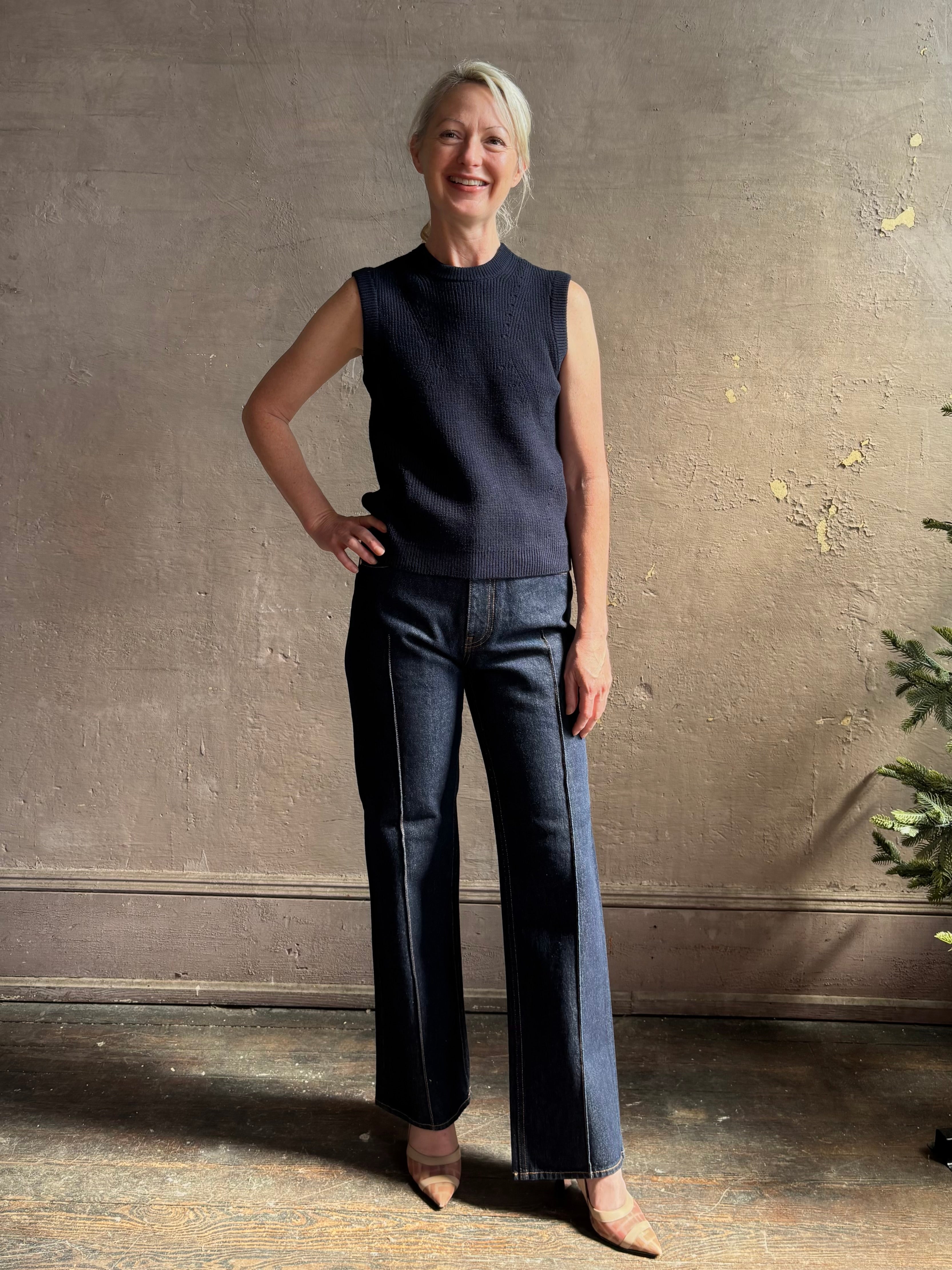 Mature woman wearing designer Margot sleeveless Knit Top from Ulla Johnson rendered in a rich midnight blue and knitted from 100% cotton with refined design details and a crew neckline