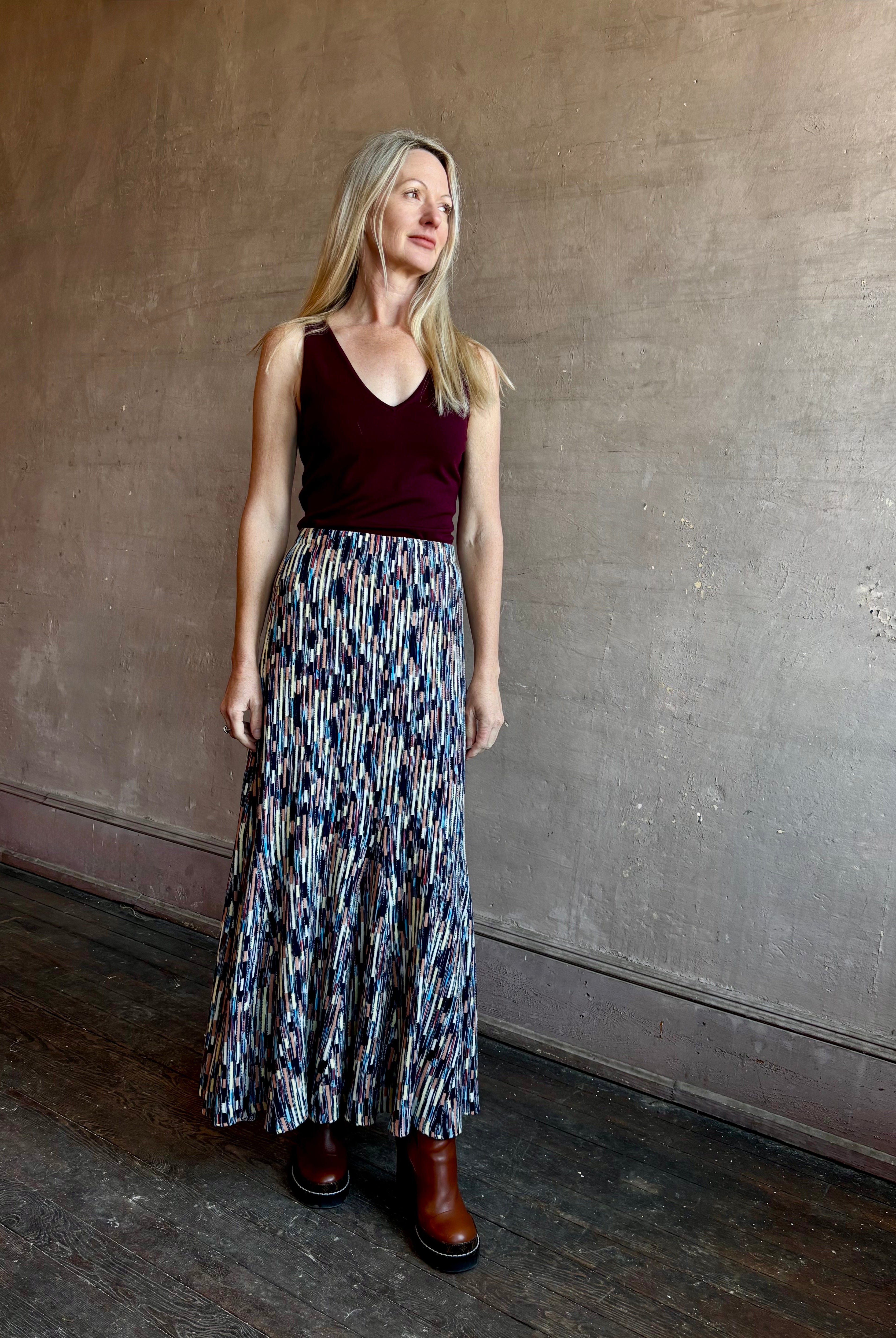 Woman wearing ULLA JOHNSON Marceline Skirt with an elastic waistband and maxi length perfect with boots or flats