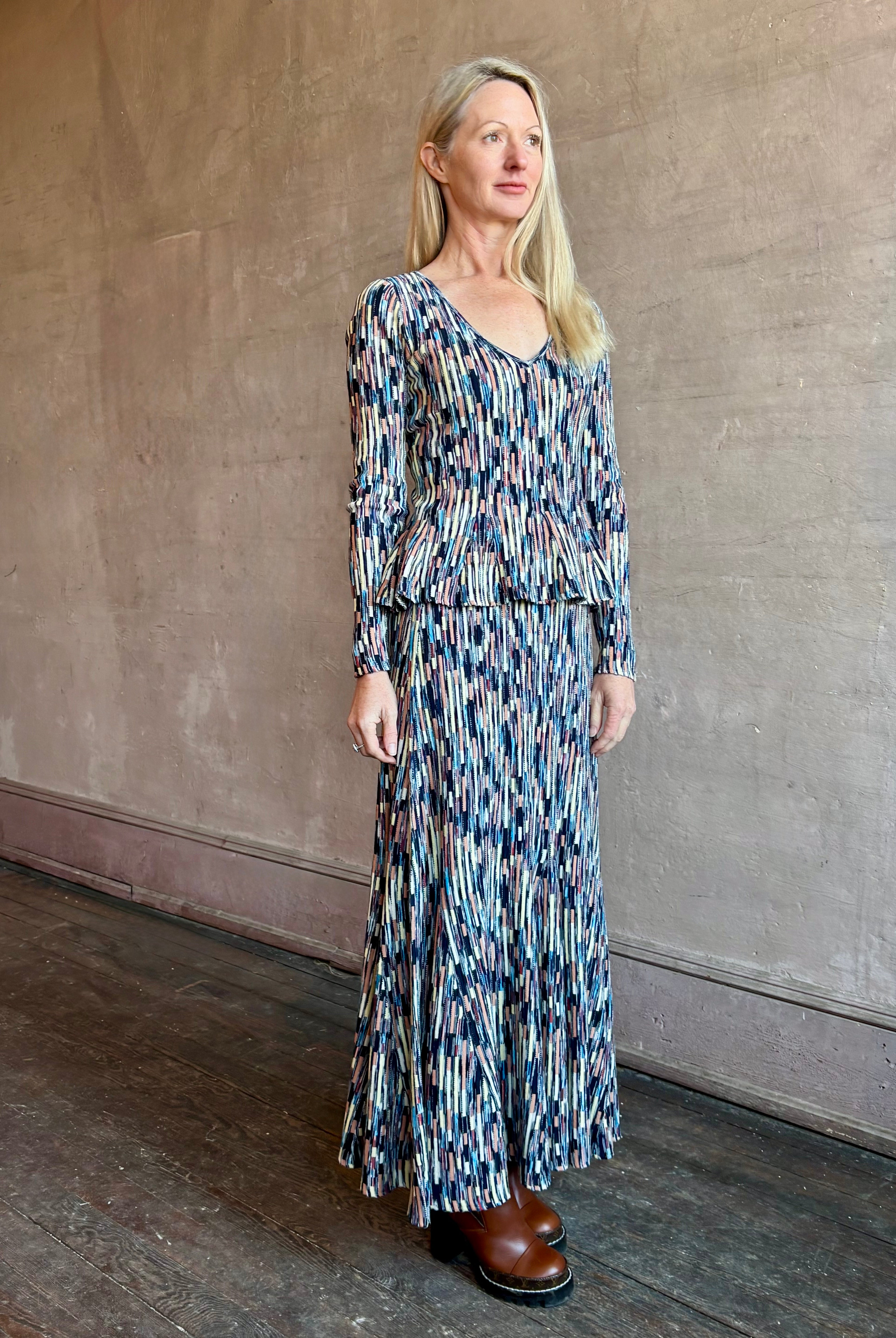 Woman wearing ULLA JOHNSON Marceline cotton knit Skirt with cascading slim rectangles in navy, aqua, pink and cream