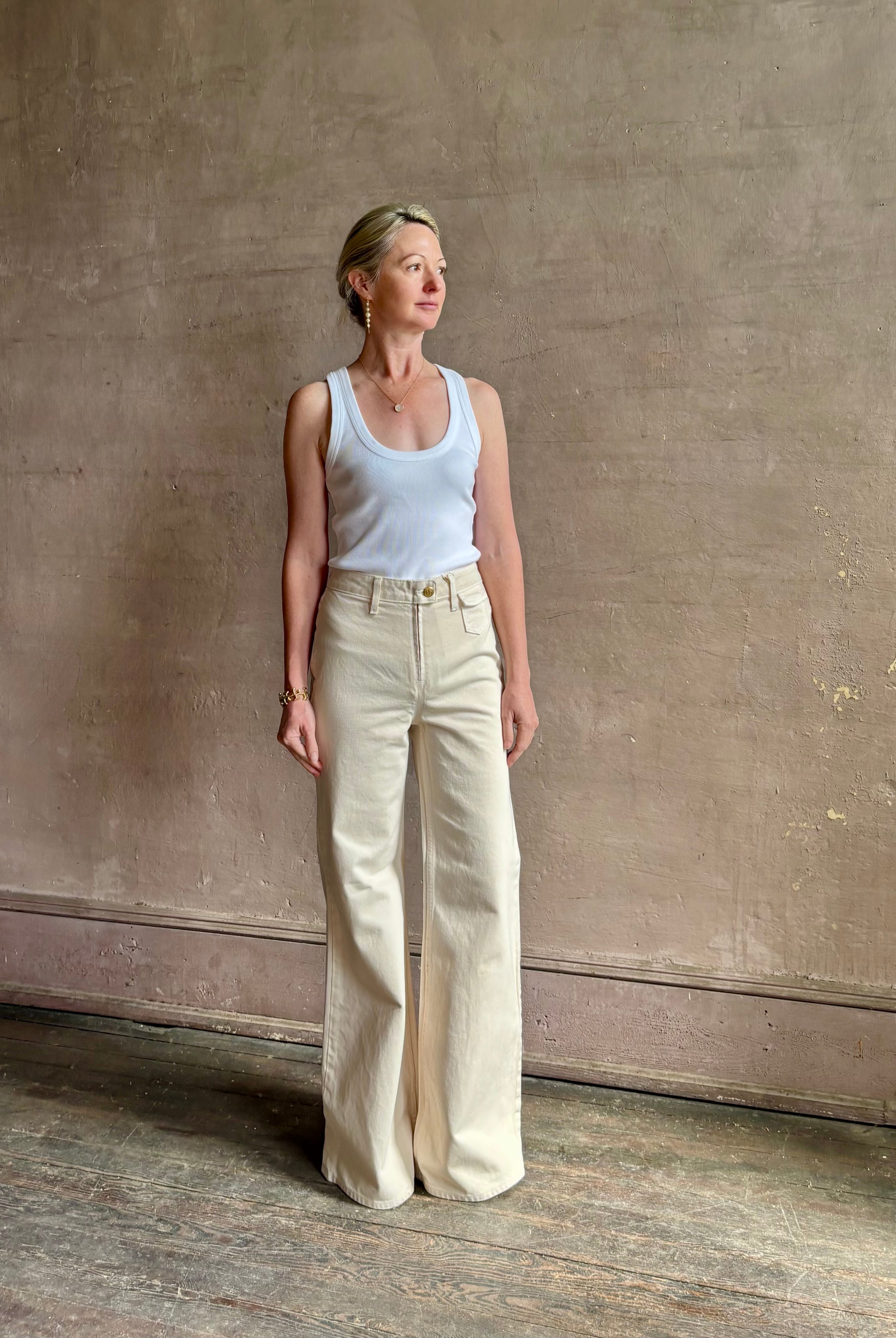Woman wearing women's luxury designer denim Ulla Johnson Odelia Jean 100% cotton high-rise wide leg