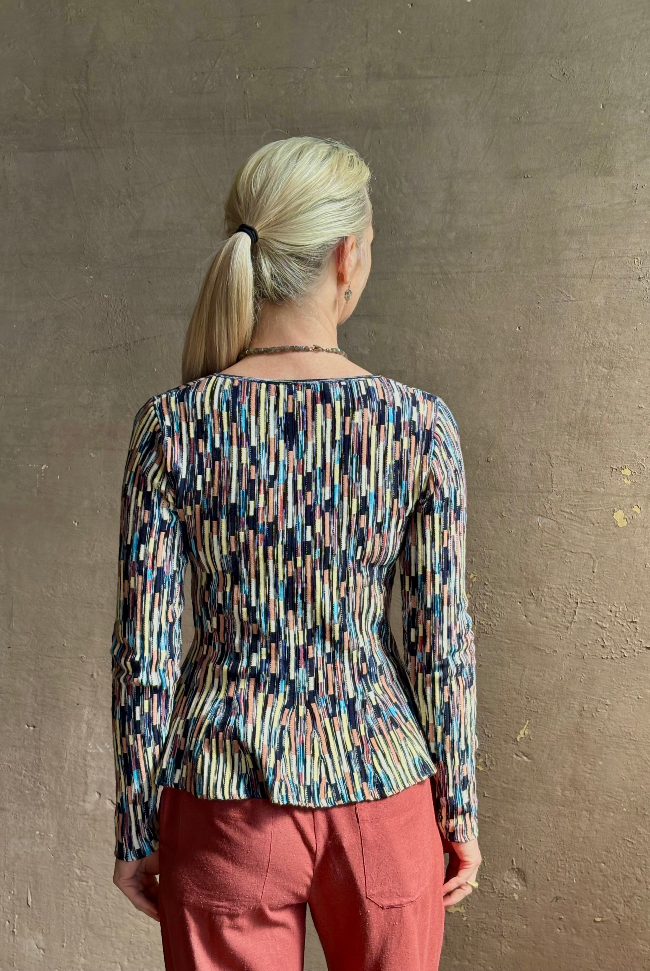 Mature woman wearing premium cotton ULLA JOHNSON Rosalia Peplum Knit Top Oasis long sleeves v-neck