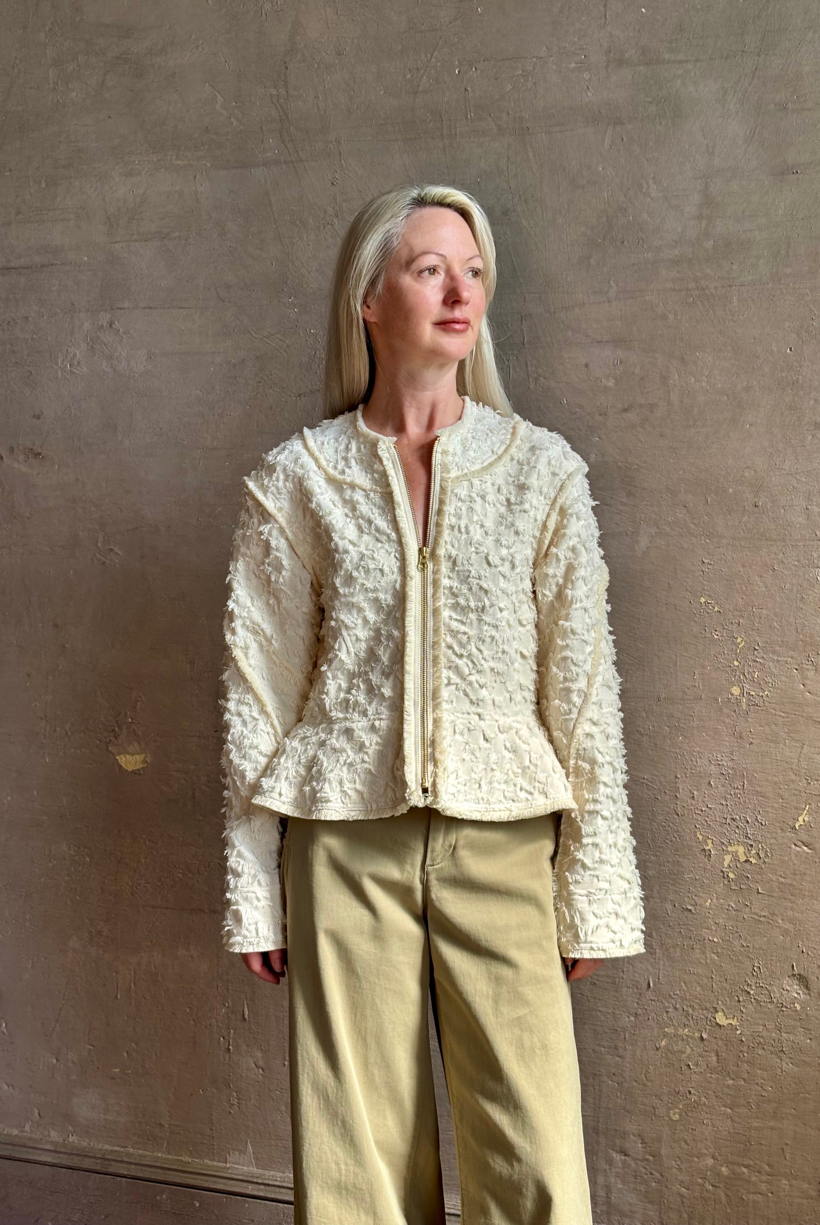 woman wearing designer Ulla Johnson Rosalind tailored peplum premium cotton Jacket checkered fringe texture