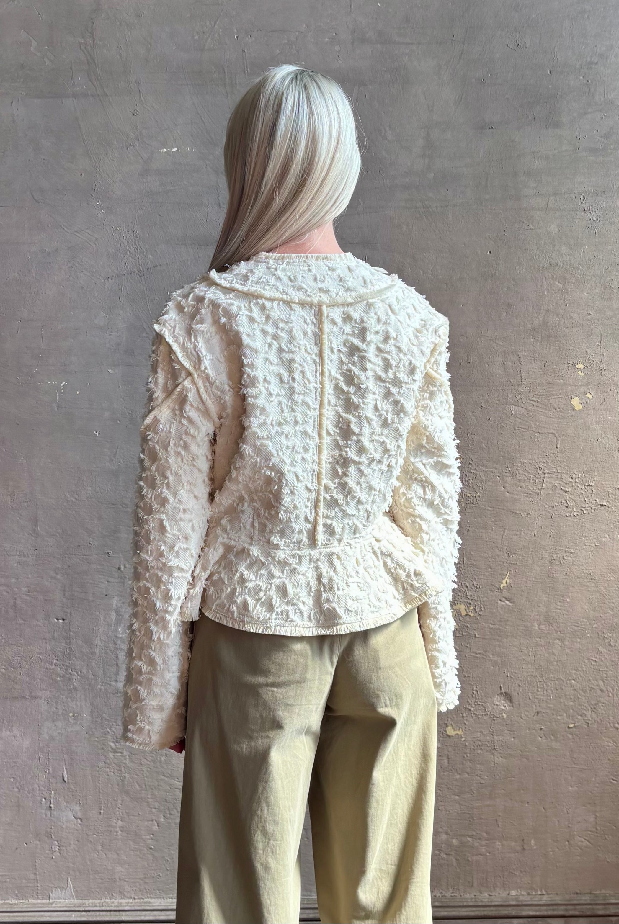 woman wearing designer Ulla Johnson Rosalind tailored peplum premium cotton Jacket checkered fringe texture