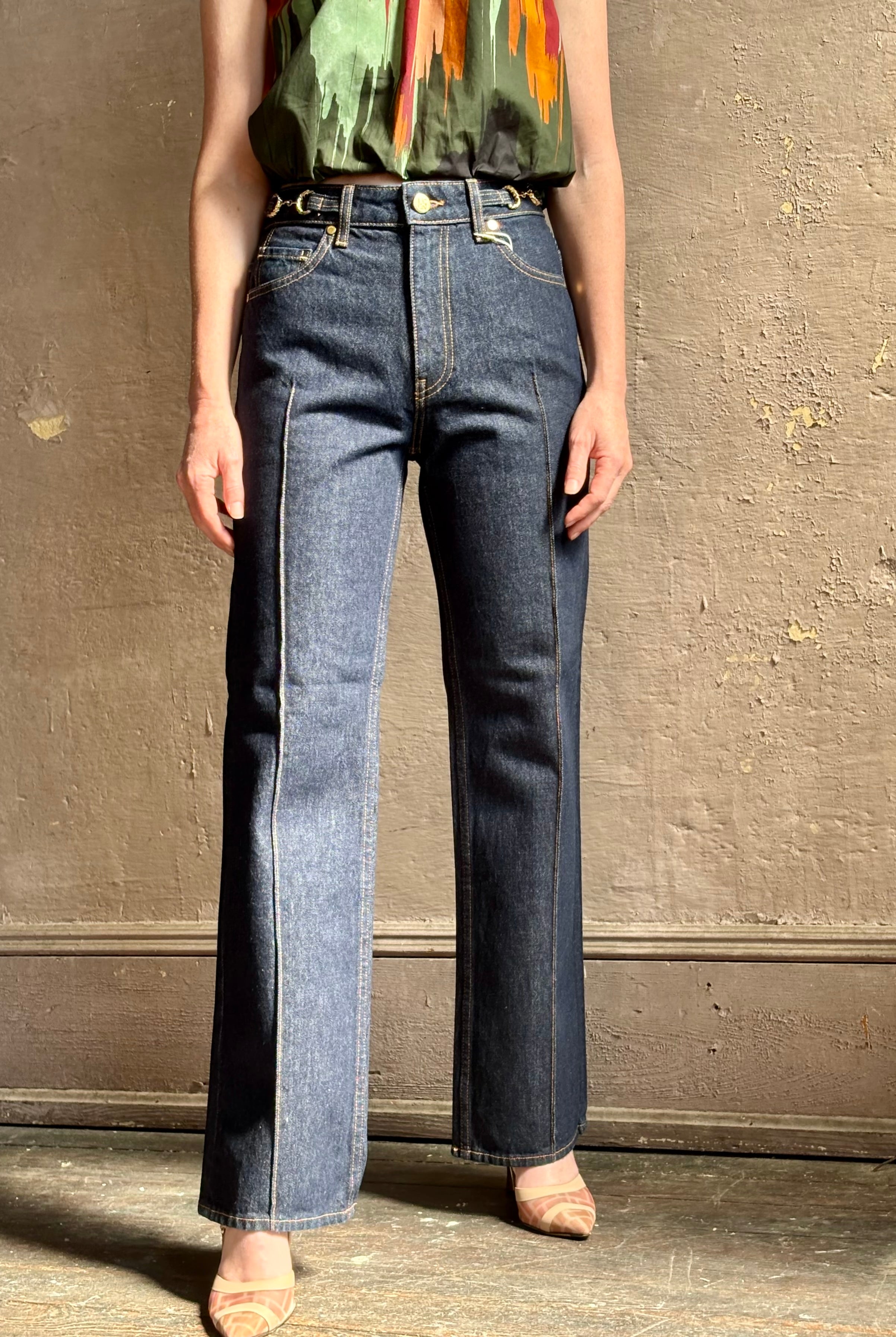 Woman wearing ULLA JOHNSON Agatha Straight Leg Pintuck Rigid Denim jean in Tigris wash with horsebit detail