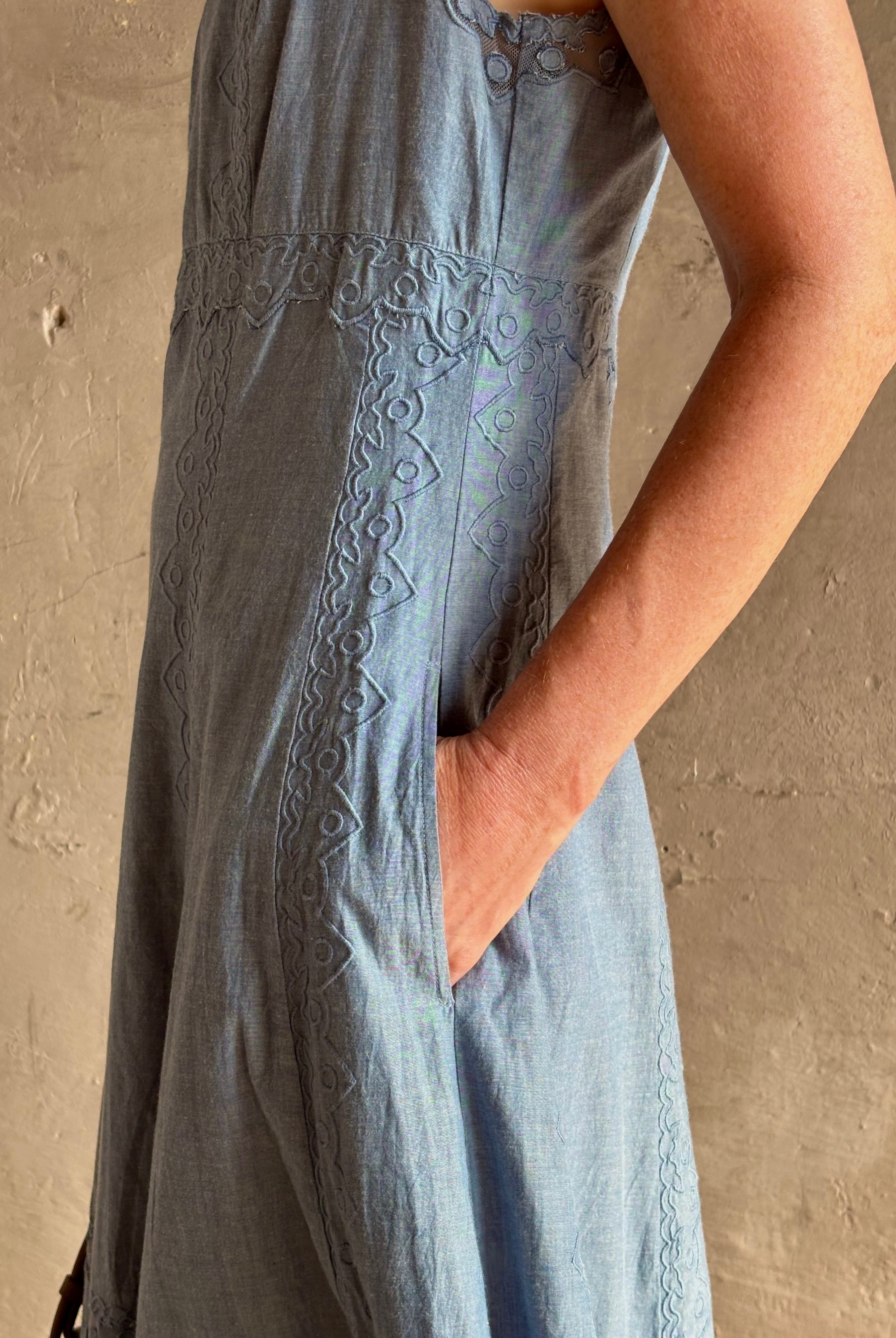 Woman wearing classic Ulla Johnson Anela midi chambray dress delicate lace details sleeveless fit and flare