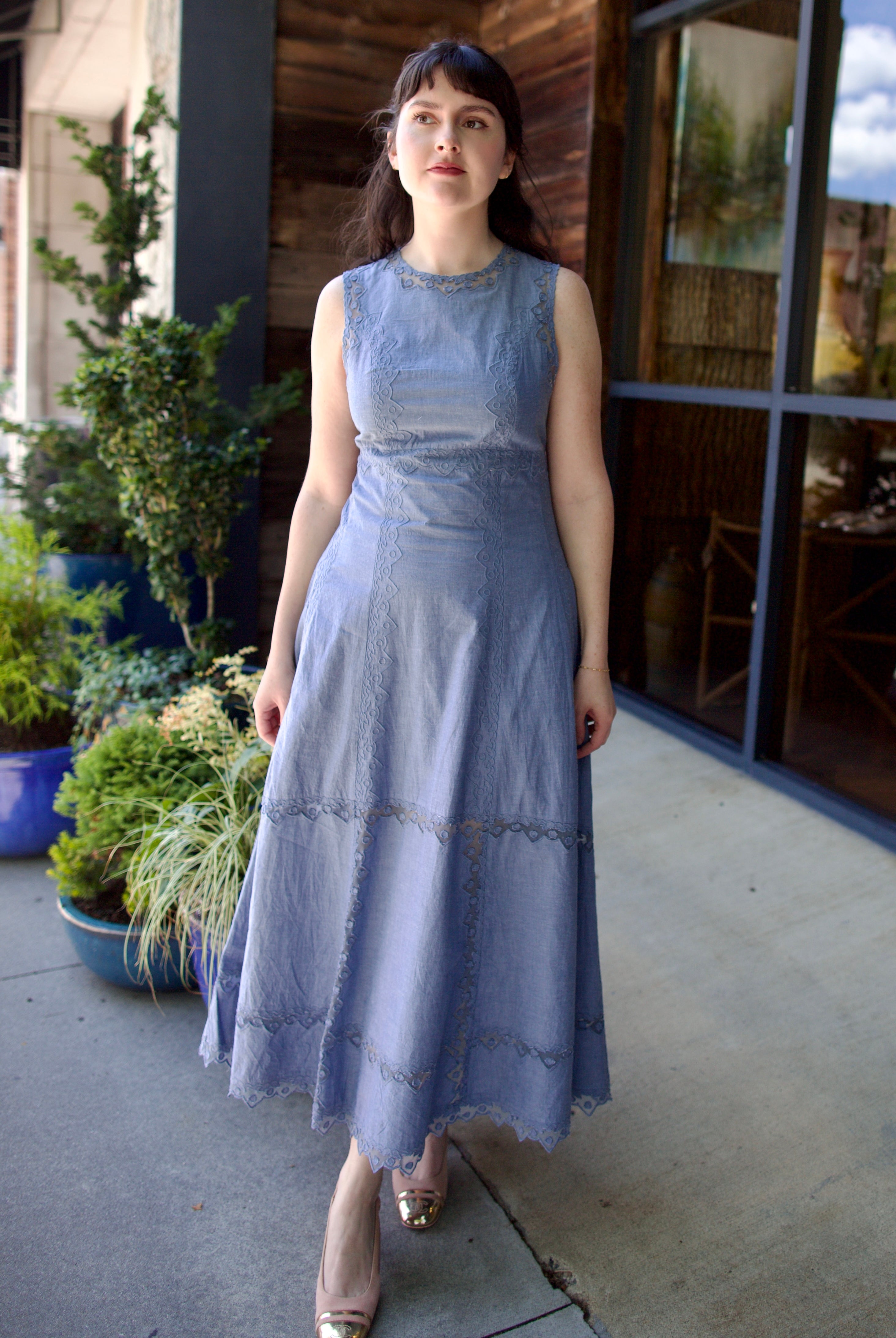 Model wearing sophisticated and classic Ulla Johnson Anela midi dress in chambray with delicate lace details