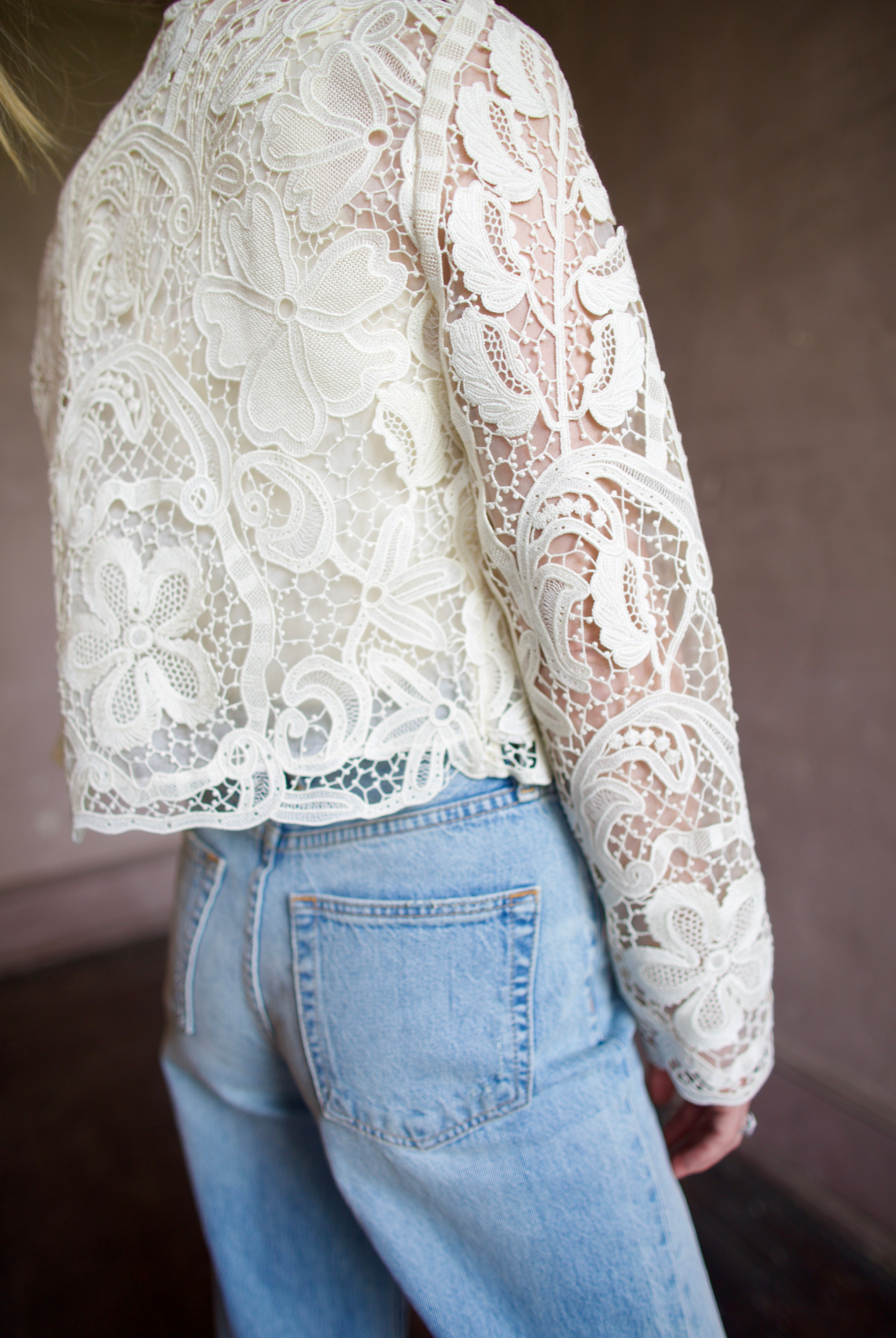 Mature woman wearing Ulla Johnson Caris Jacket delicate white lace button down features embroidered florals