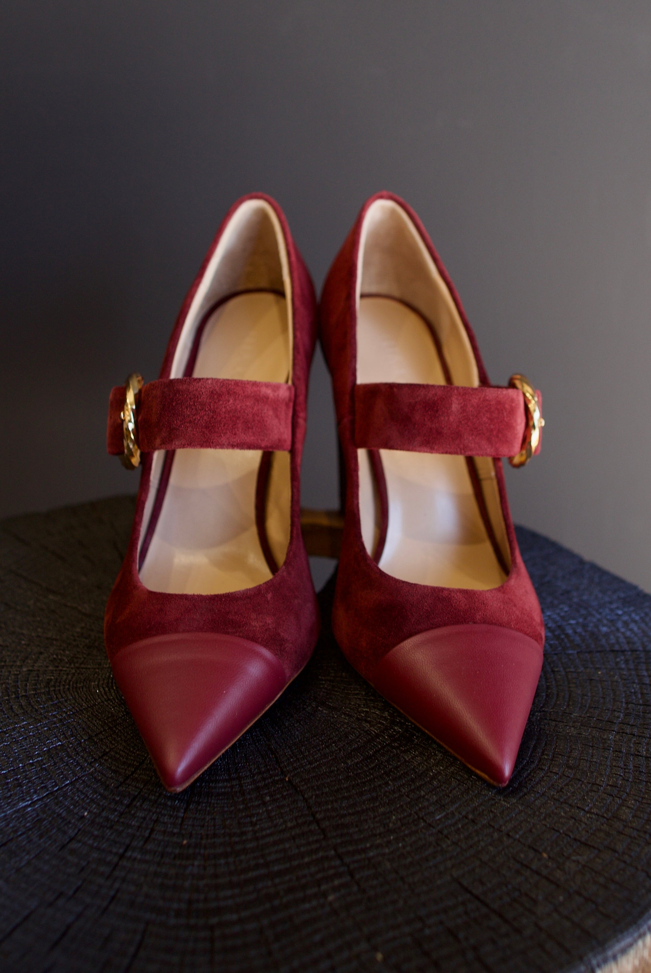 Image featuring the Kiki burgundy suede heels by Ulla Johnson with a pointed leather toe, gold finish buckle closure and a 3.5" tall block heel.
