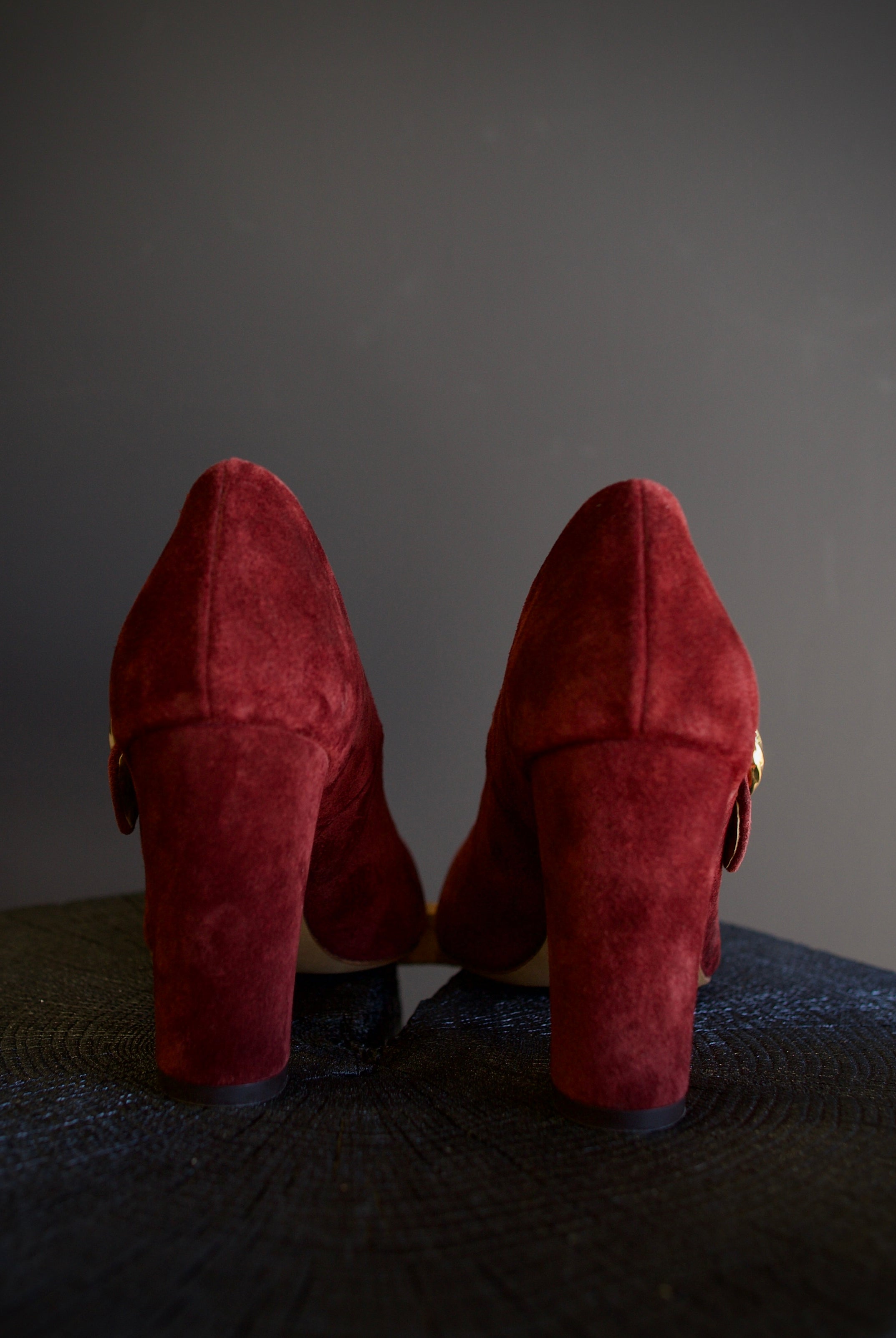 Image featuring the Kiki burgundy suede heels by Ulla Johnson with a pointed leather toe, gold finish buckle closure and a 3.5" tall block heel.
