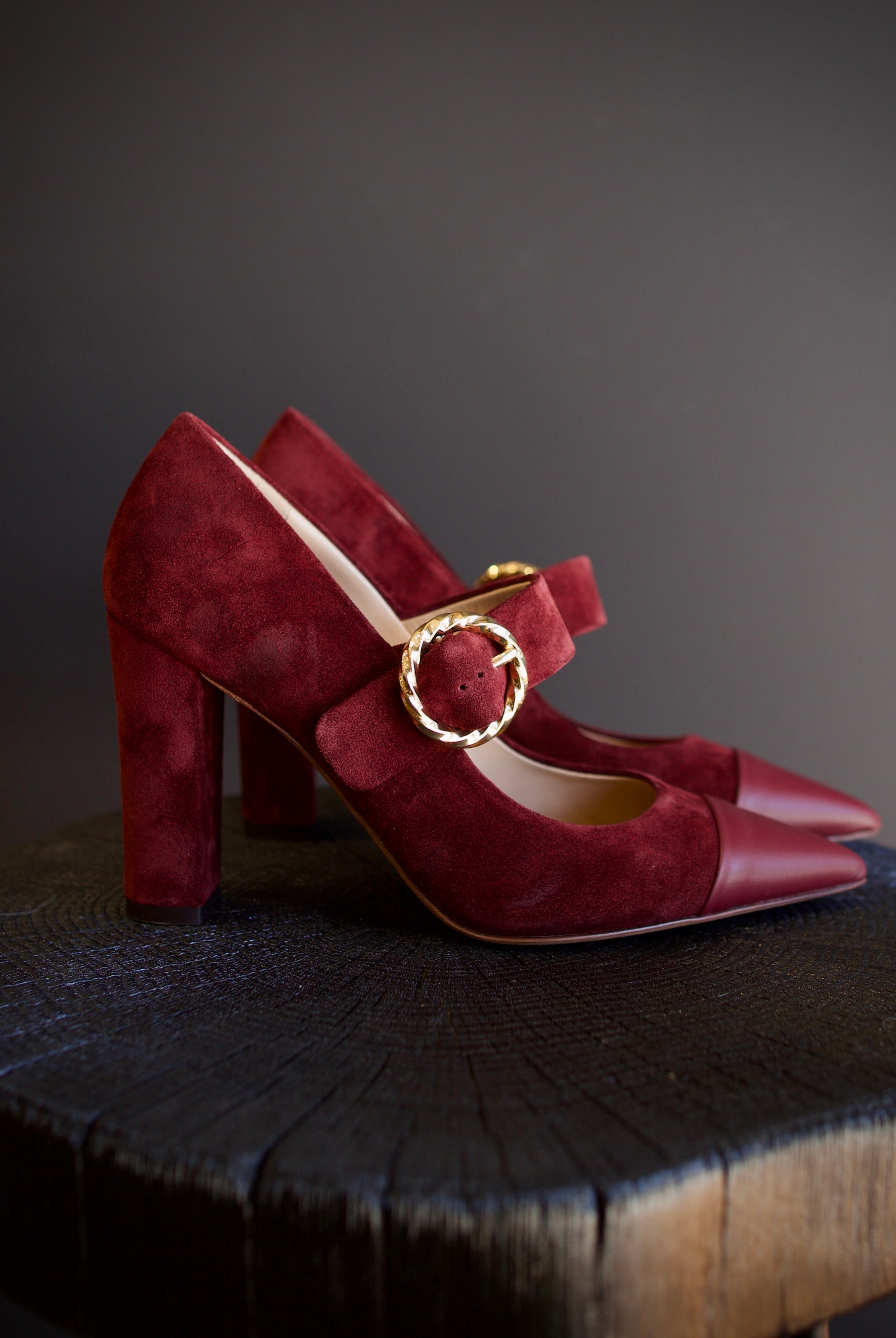 Image featuring the Kiki burgundy suede heels by Ulla Johnson with a pointed leather toe, gold finish buckle closure and a 3.5" tall block heel.