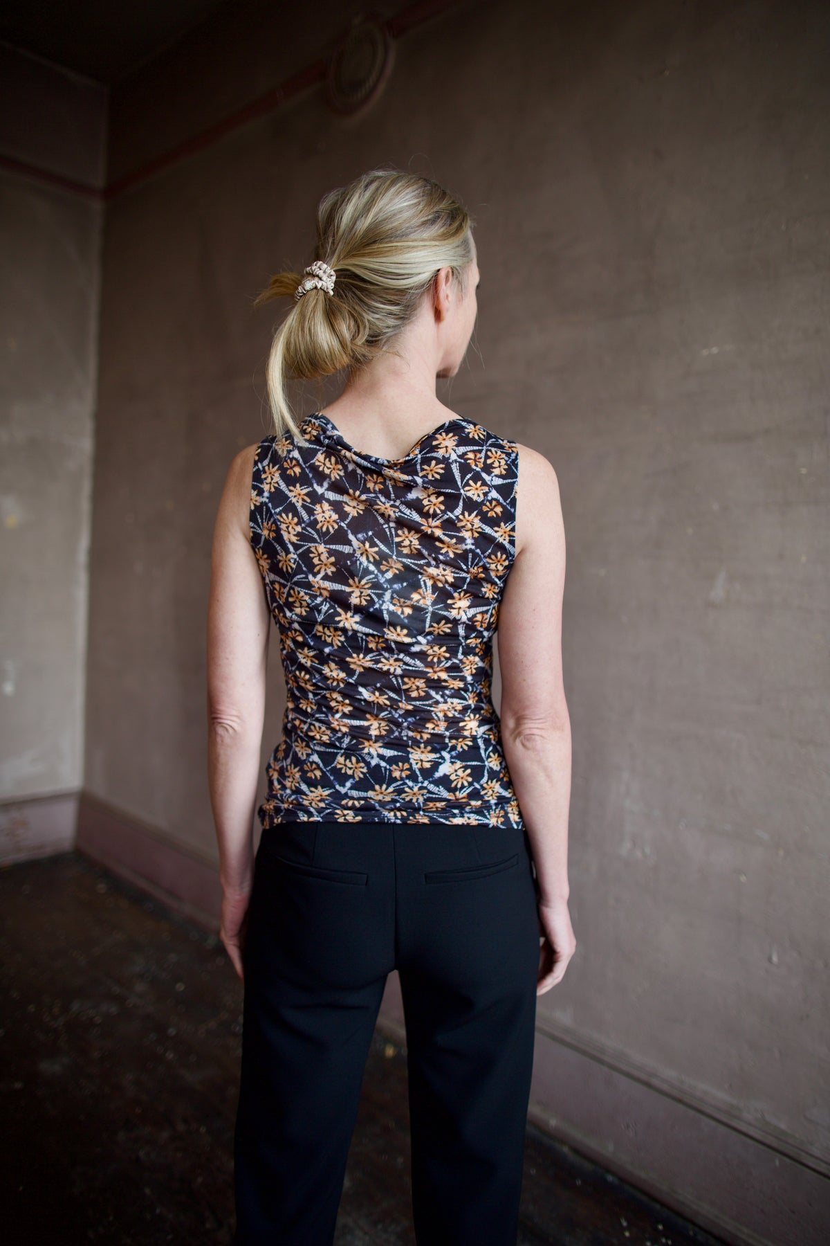 Mature woman wearing ulla johnson medea top in Aura floral print comfortable lightweight lyocell fabric sleeveless with slim fit