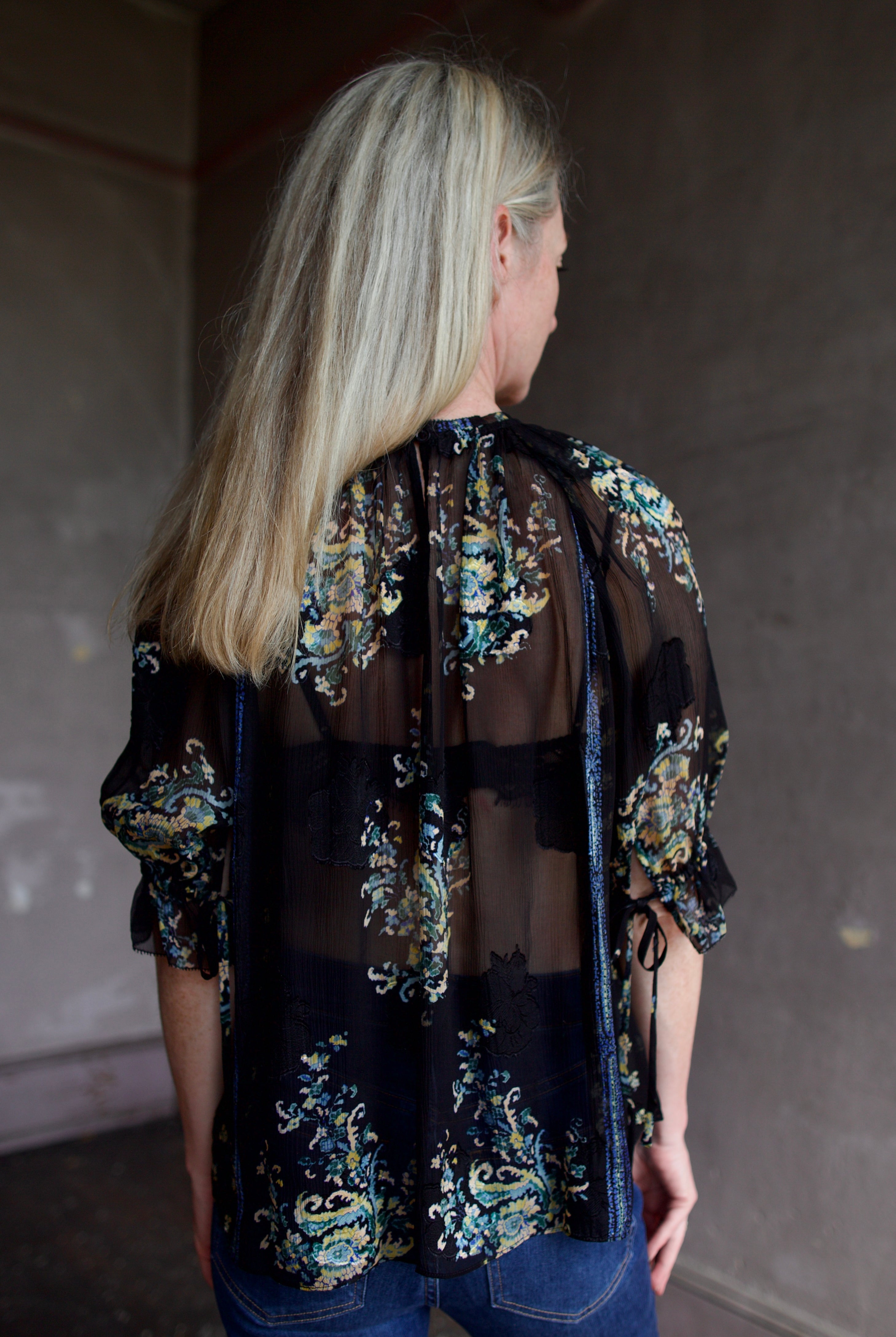 Mature model wearing high-end designer Ulla Johnson Pippa sheer Short Sleeve Blouse in twilight