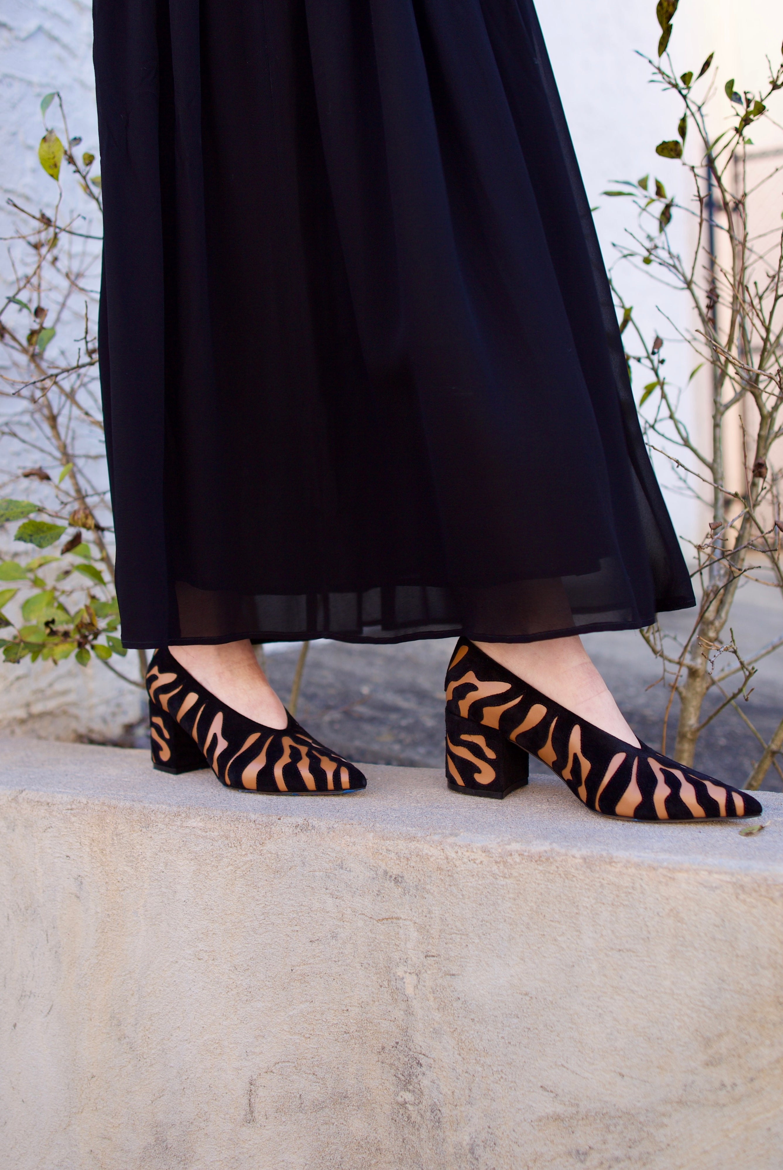 image of woman wearing the Ulla Johnson Polline pumps and the Miya skirt