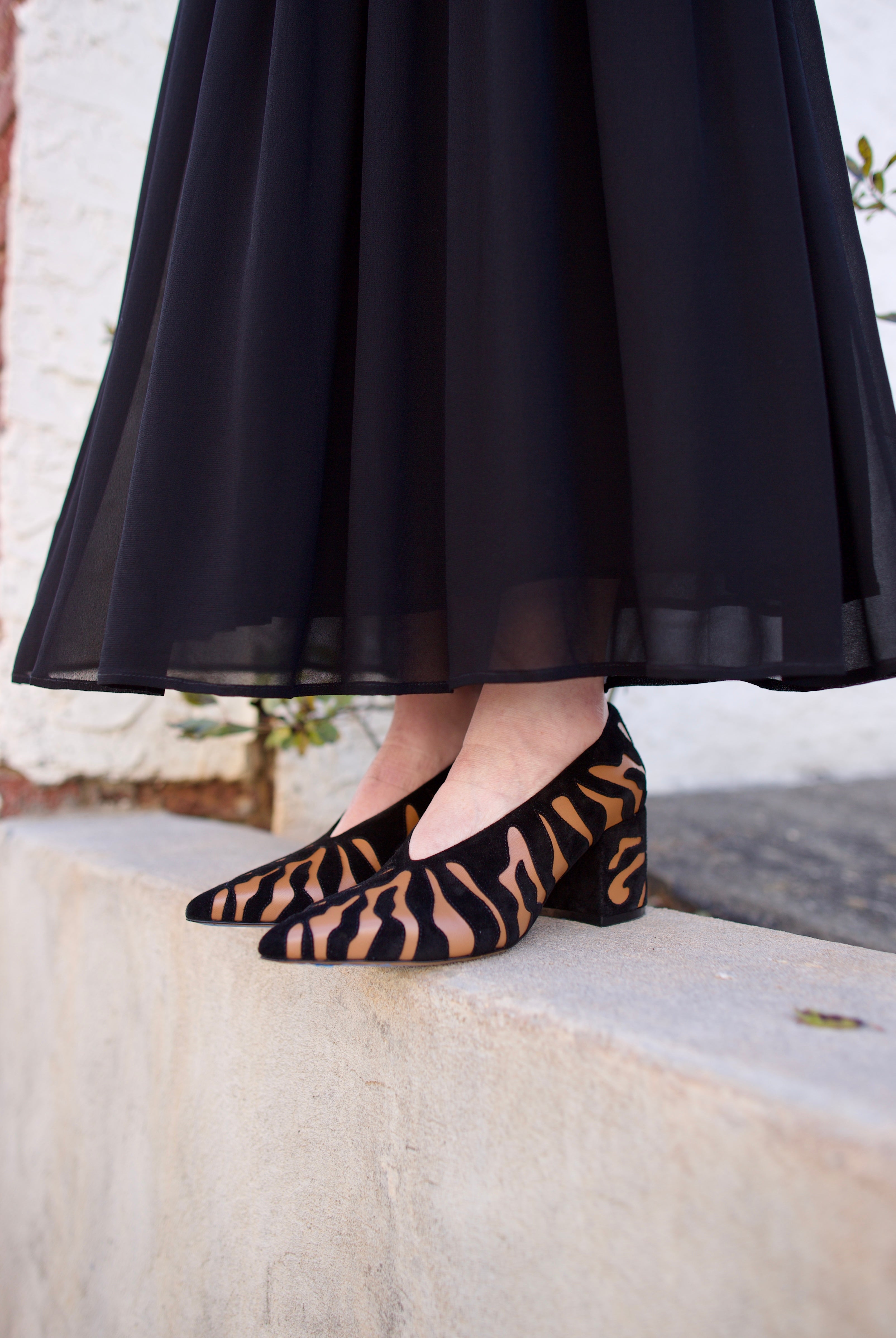 image of woman wearing the Ulla Johnson Polline pumps and the Miya skirt