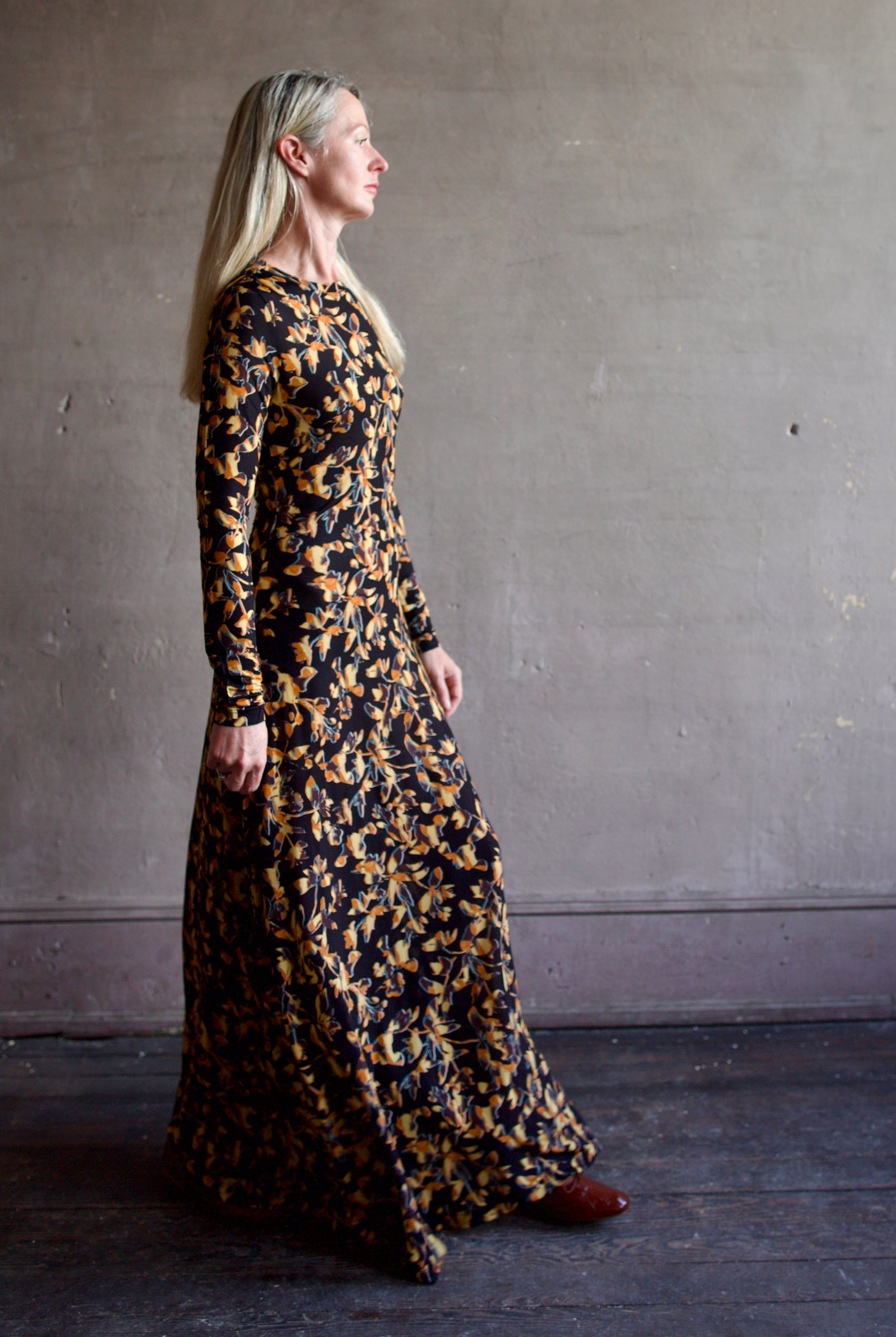 Model wearing the Amari dress from designer Ulla Johnson featuring long sleeves maxi length & fall patterned