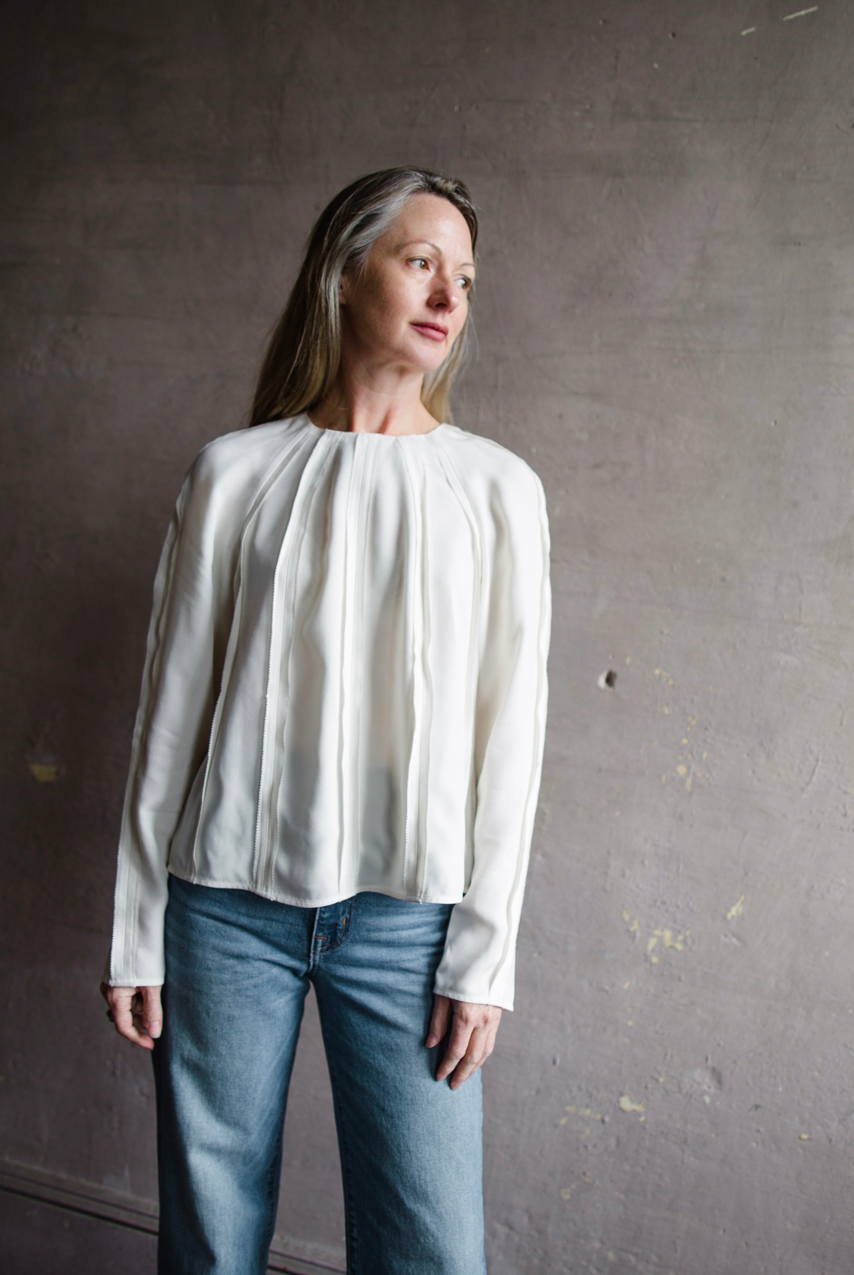 Image of a woman wearing the Ulla Johnson Kavi Blouse and Re/Done 90's High Rise Loose Jeans