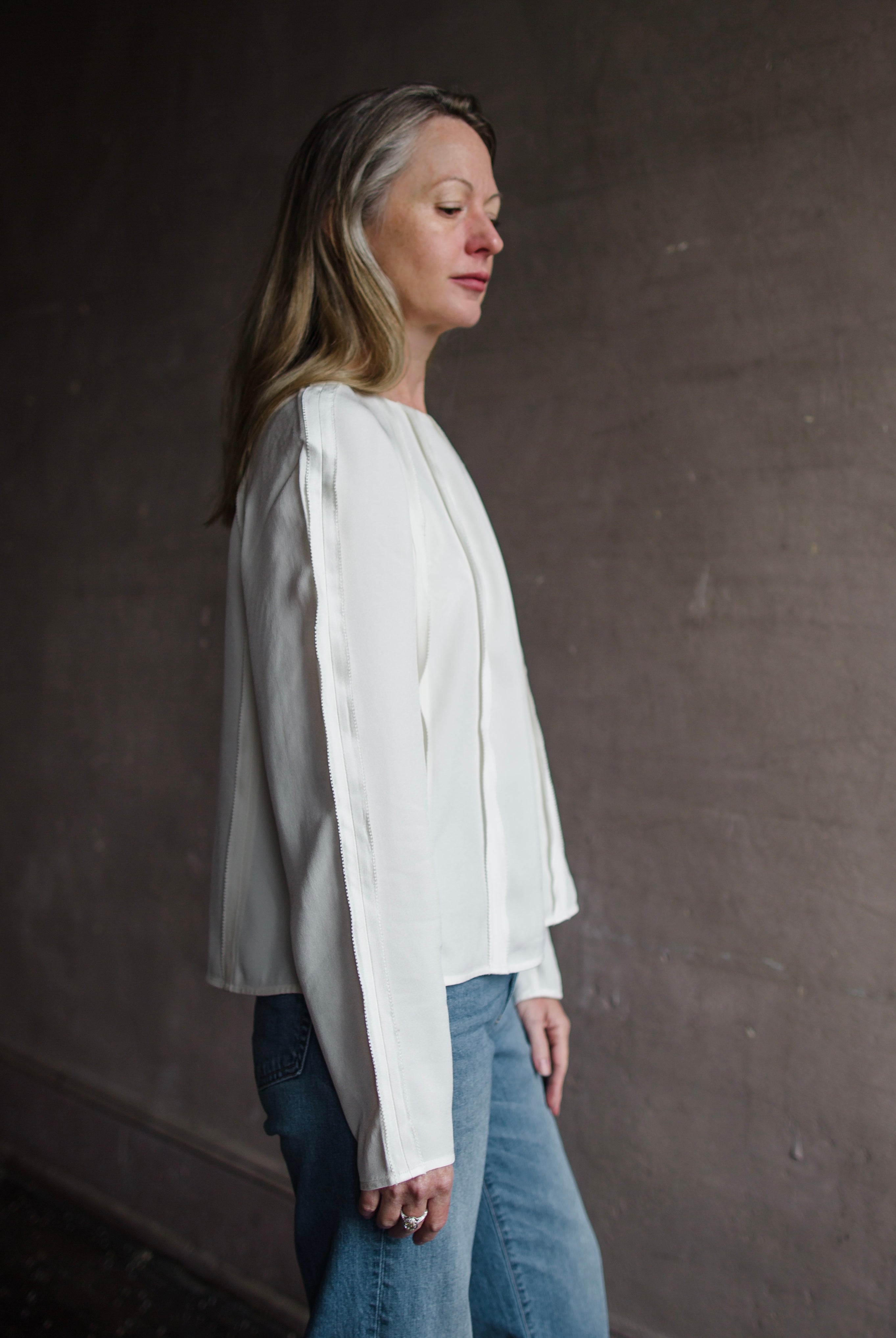 Image of a woman wearing the Ulla Johnson Kavi Blouse and Re/Done 90's High Rise Loose Jeans