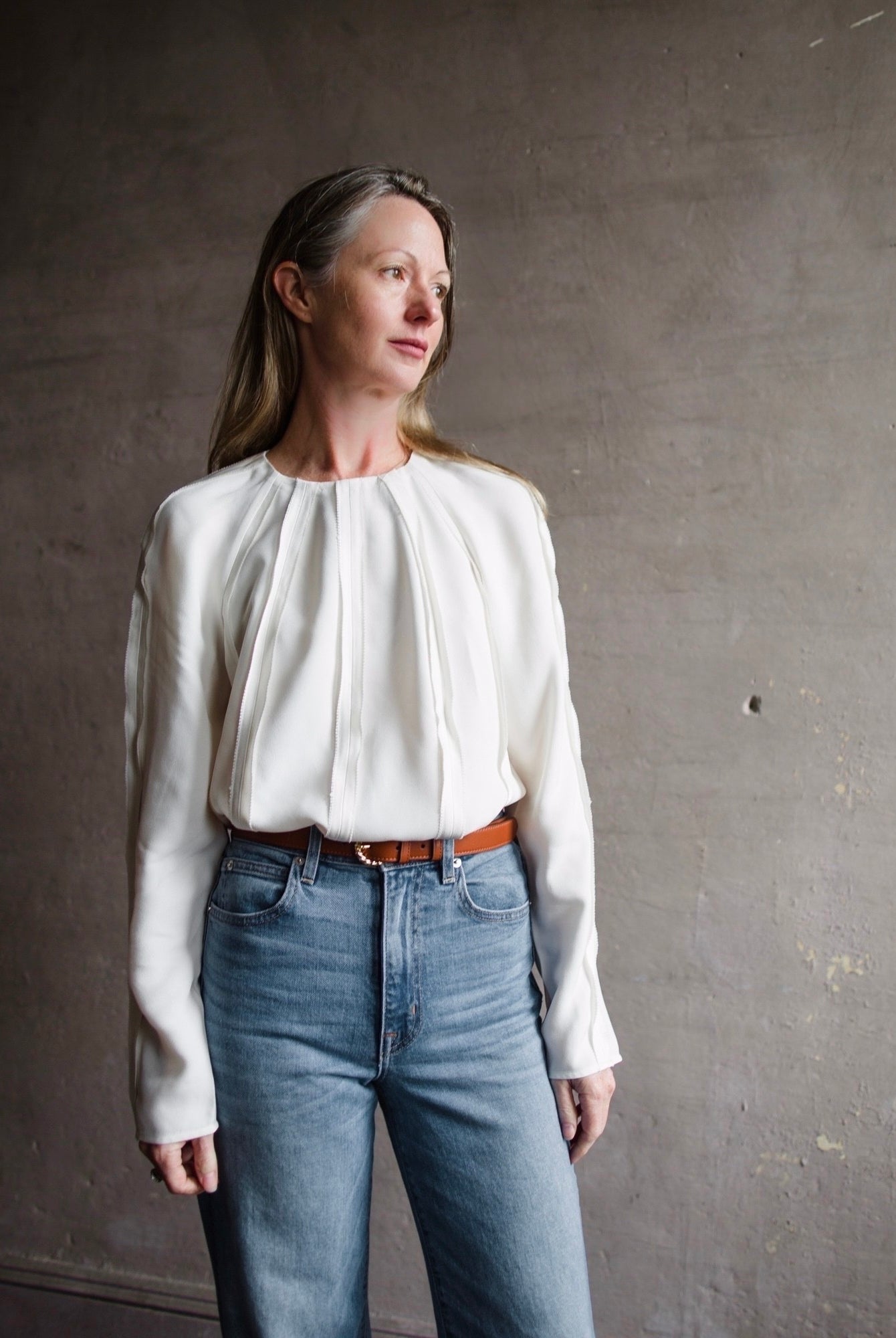 Image of a woman wearing the Ulla Johnson Kavi Blouse, Ulla Johnson Gia Belt and Re/Done 90's High Rise Loose Jeans