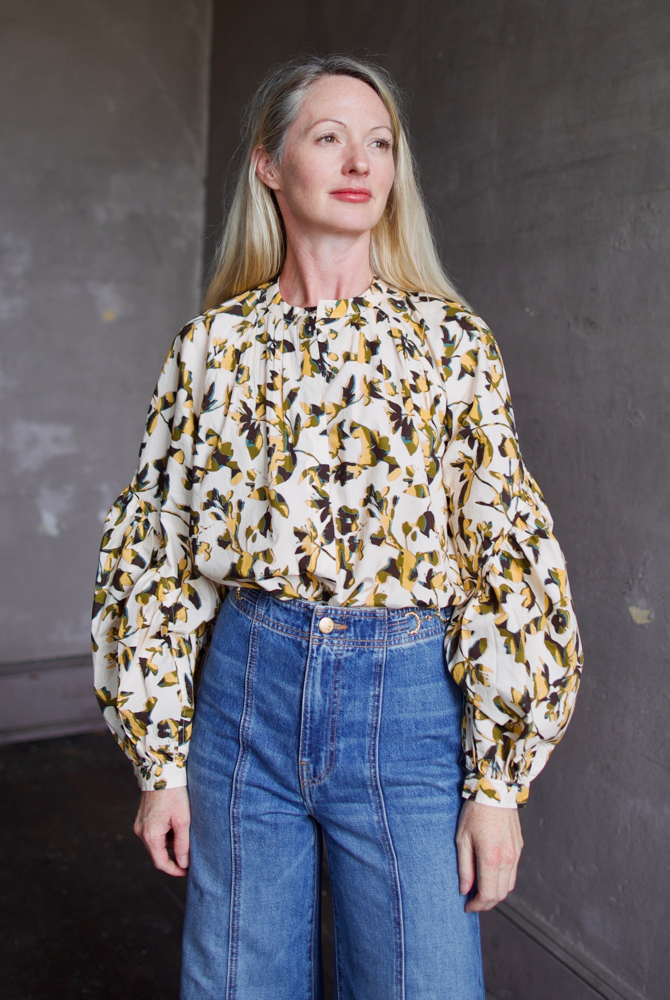 Image of mature woman wearing sophisticated Ulla Johnson Rowena Long Sleeve cotton poplin Blouse in Lucent cream with yellow and green floral print
