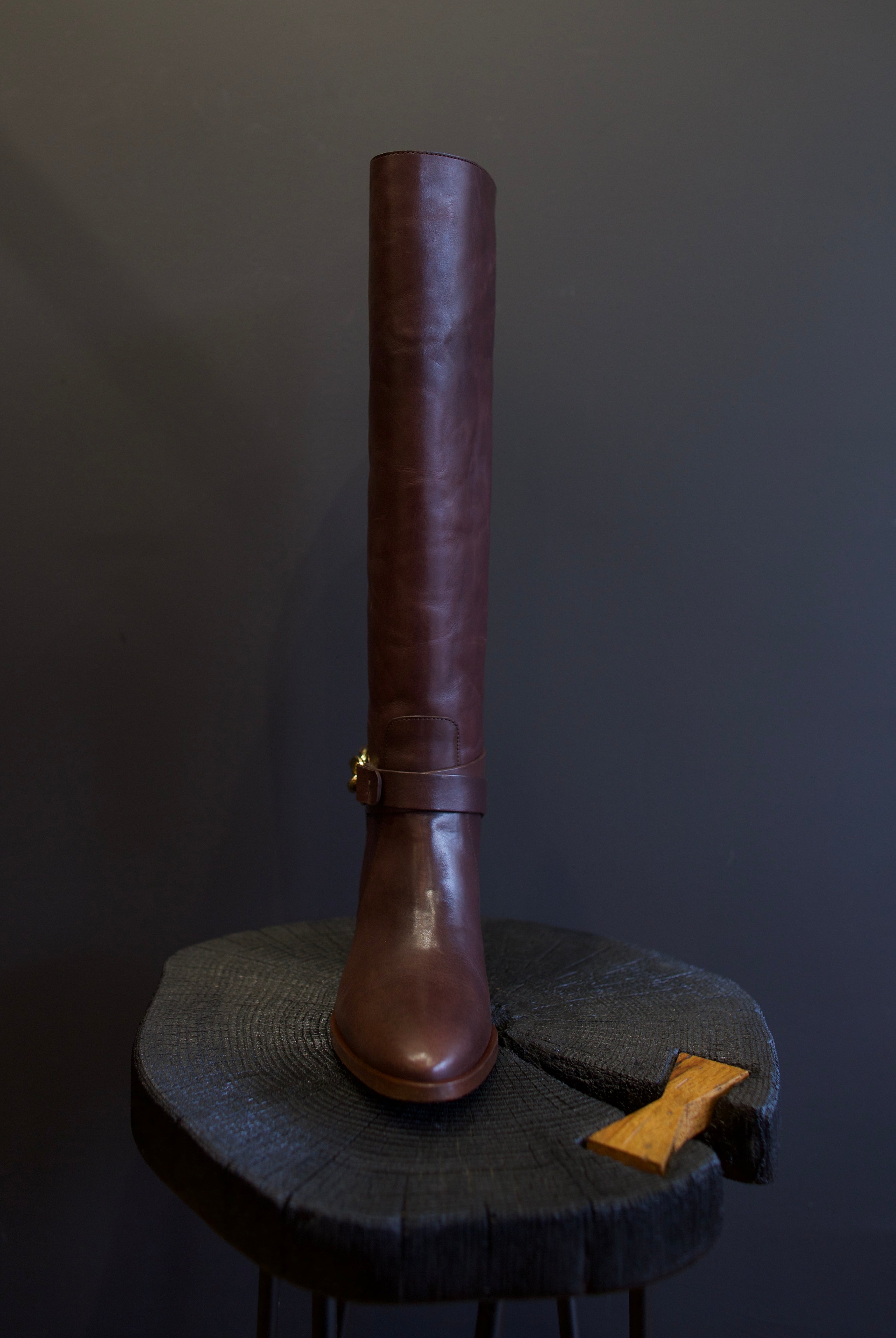 Image of the Ulla Johnson willow cowboy boot with a  knee-high length, pointed toe, and rests on a stacked block heel.