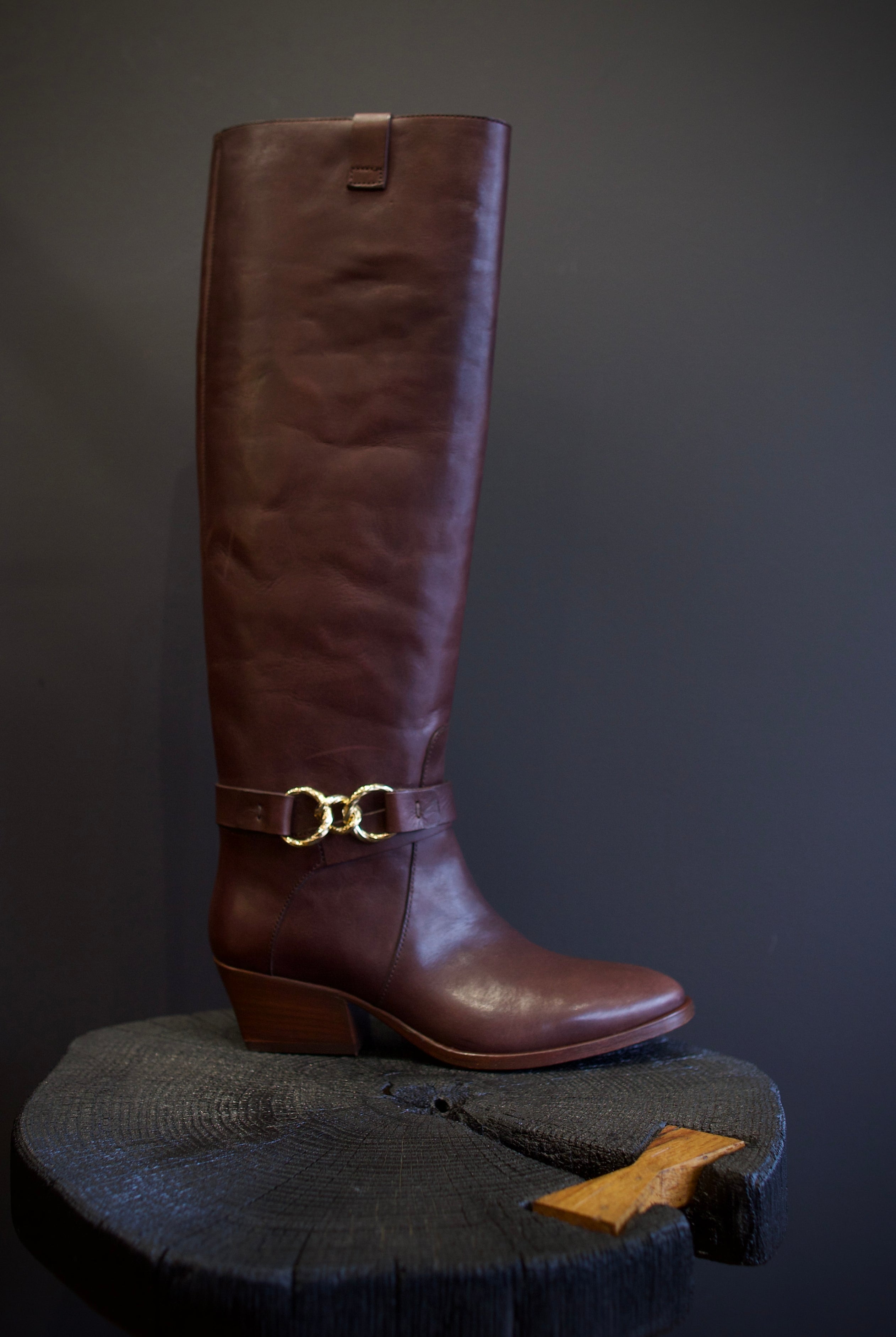 Image of the Ulla Johnson willow cowboy boot with a  knee-high length, pointed toe, and rests on a stacked block heel.
