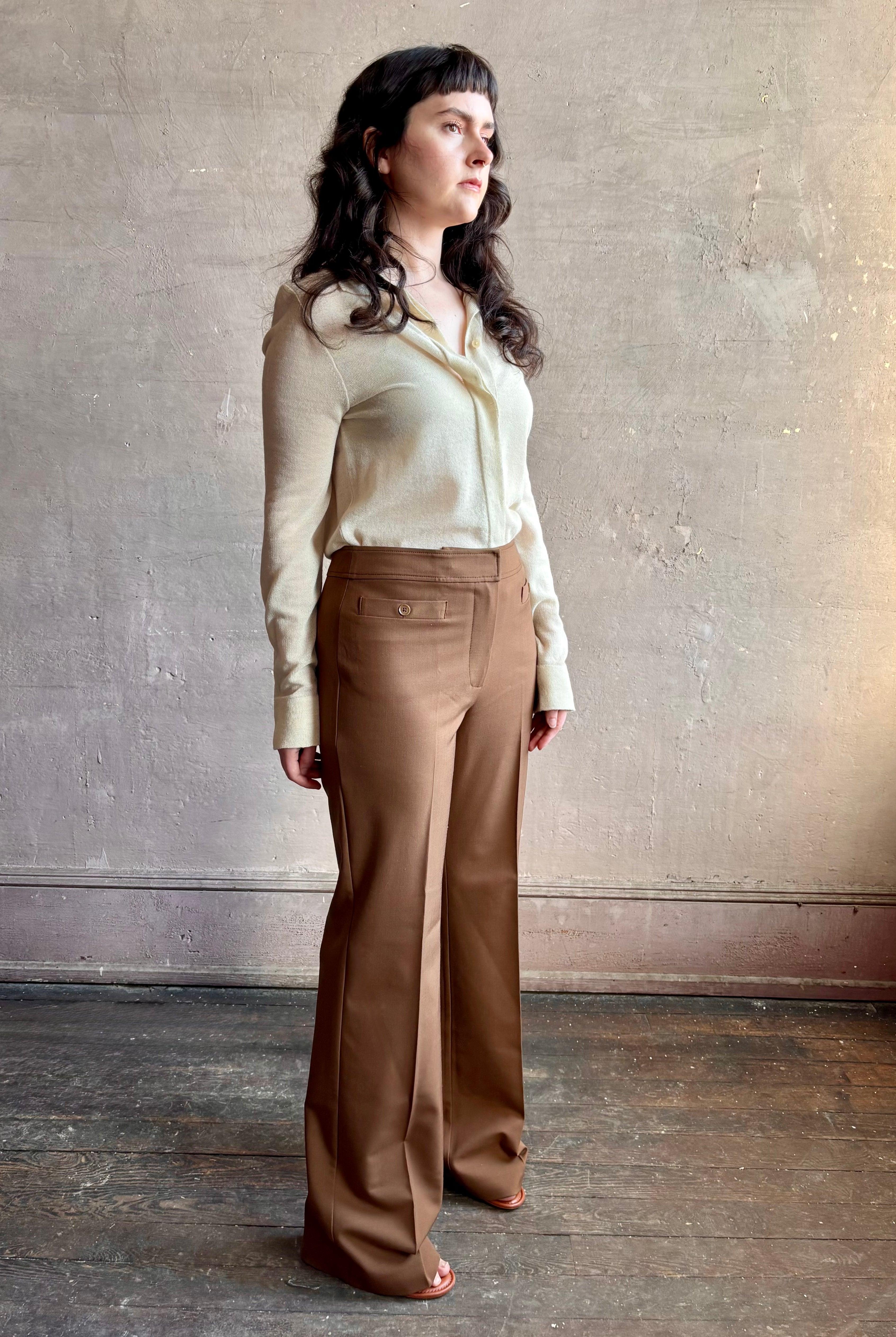 Image of woman wearing premium wool tailored blanca trousers by luxury designer Ulla Johnson Blanca in a neutral medium brown