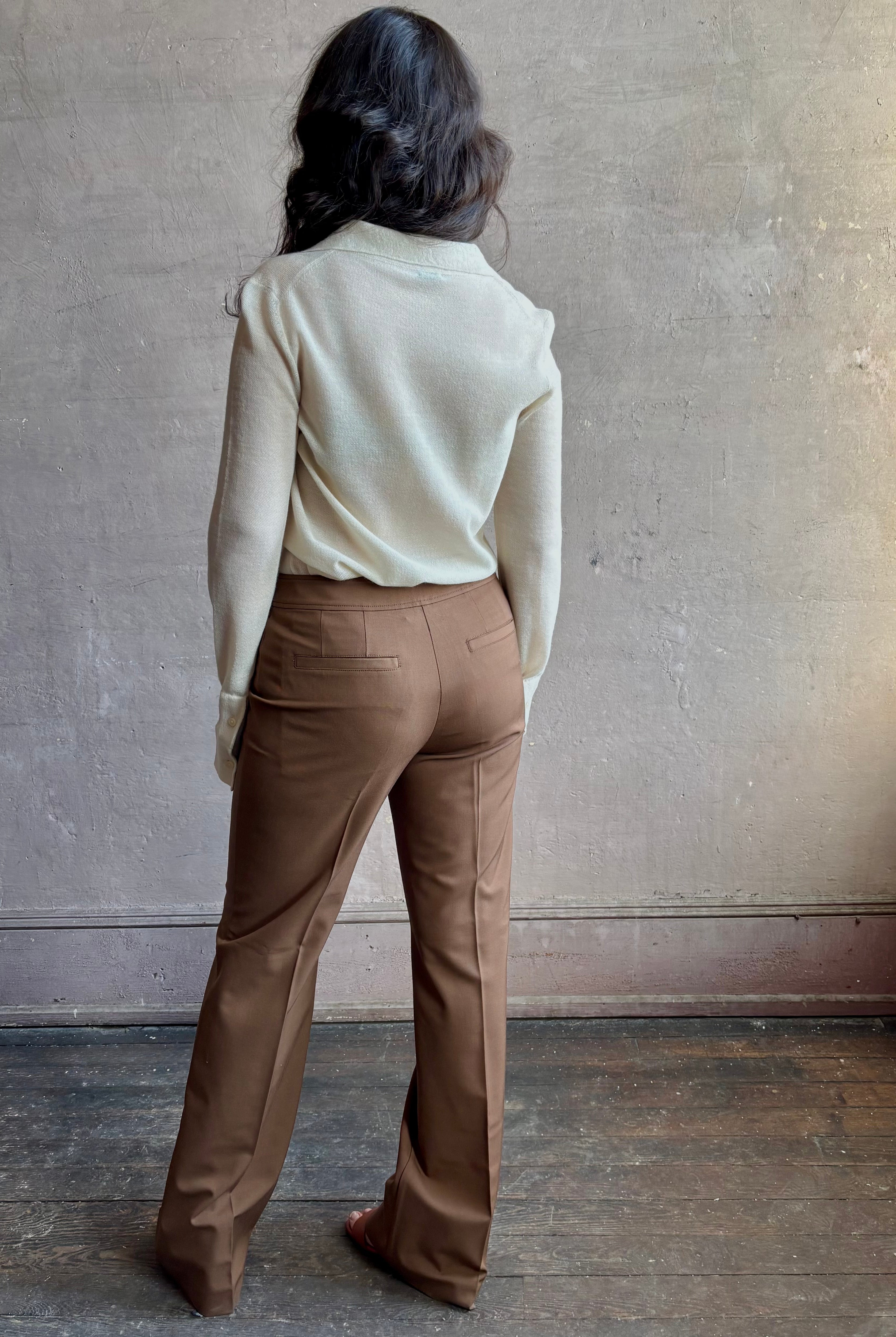 Image of woman wearing premium wool tailored blanca trousers by luxury designer Ulla Johnson Blanca in a neutral medium brown