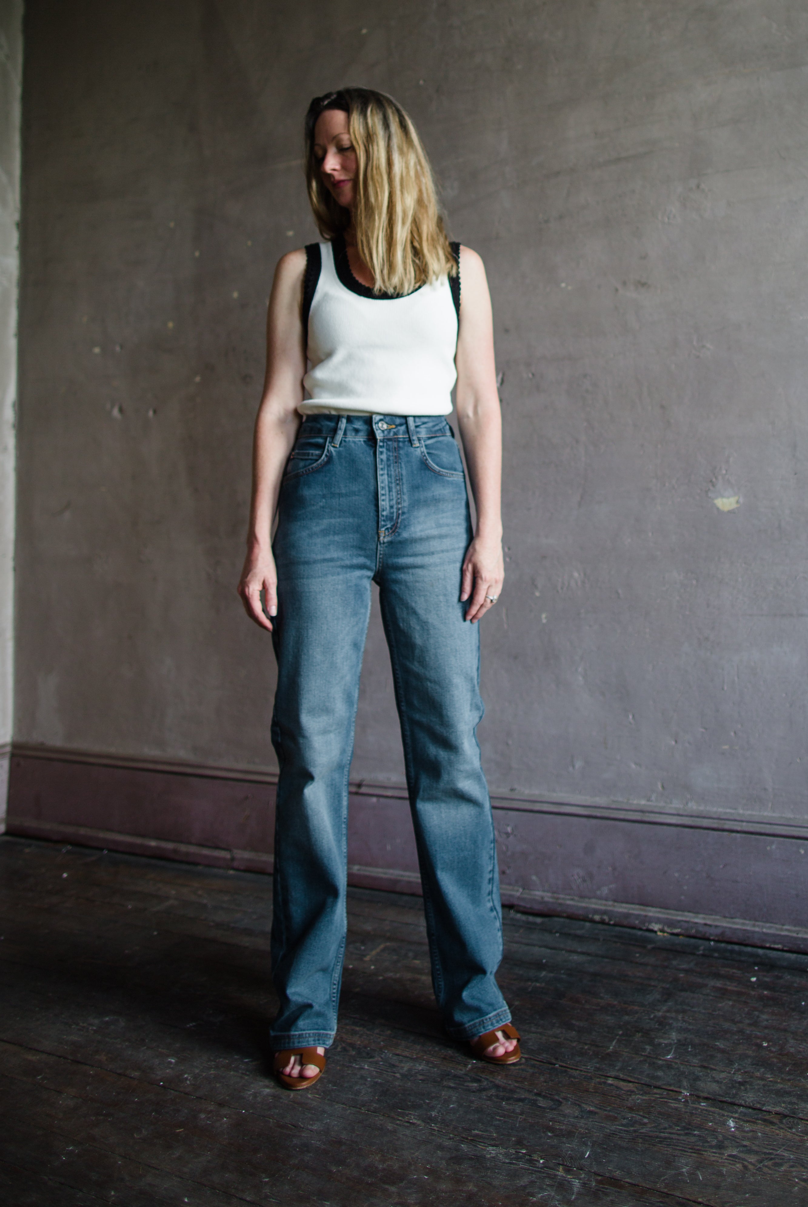 Mature woman wearing Vanessa Bruno Benito jeans with a zip fly, high rise, straight leg, full length medium wash