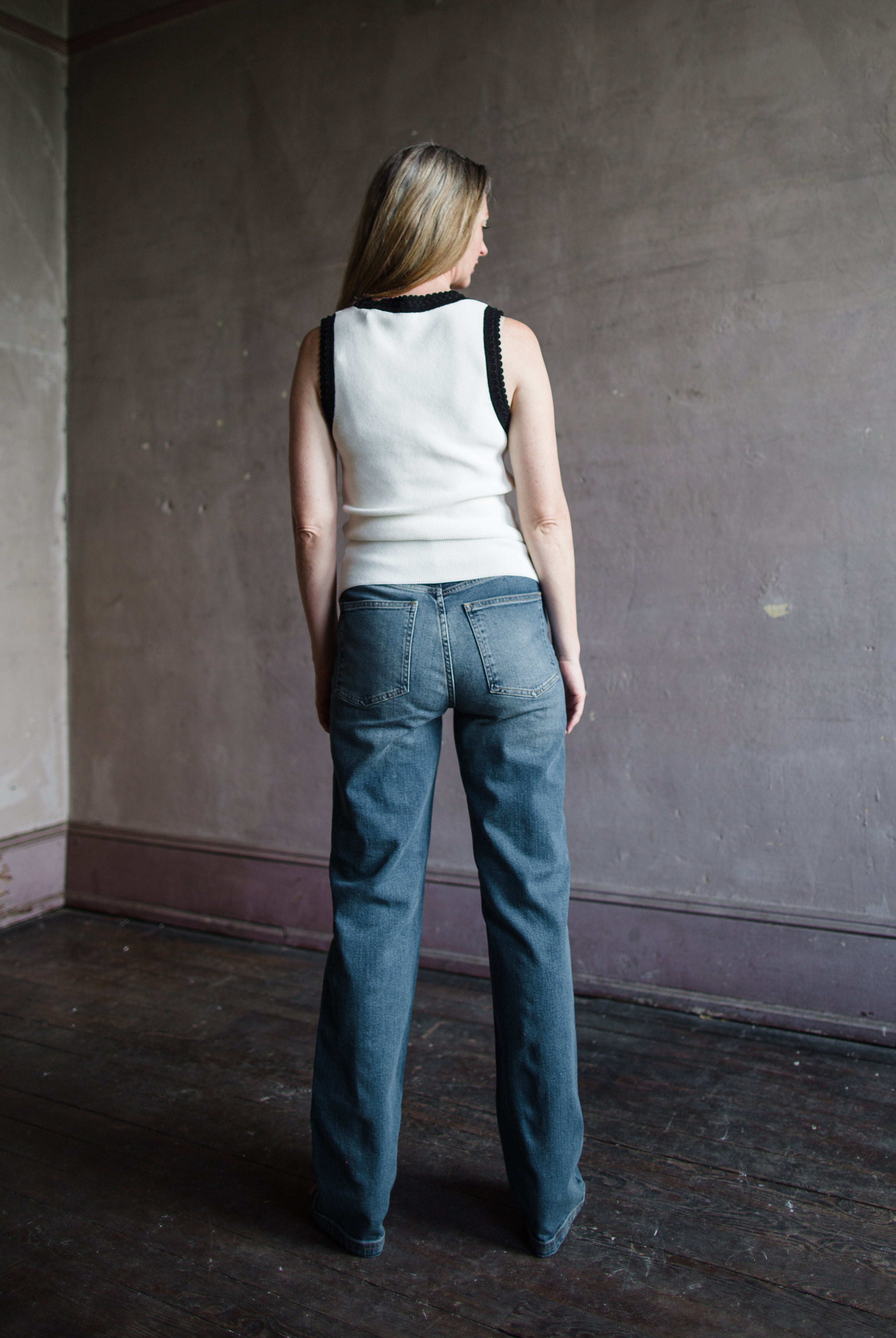 Mature woman wearing Vanessa Bruno Benito jeans with a zip fly, high rise, straight leg, full length medium wash