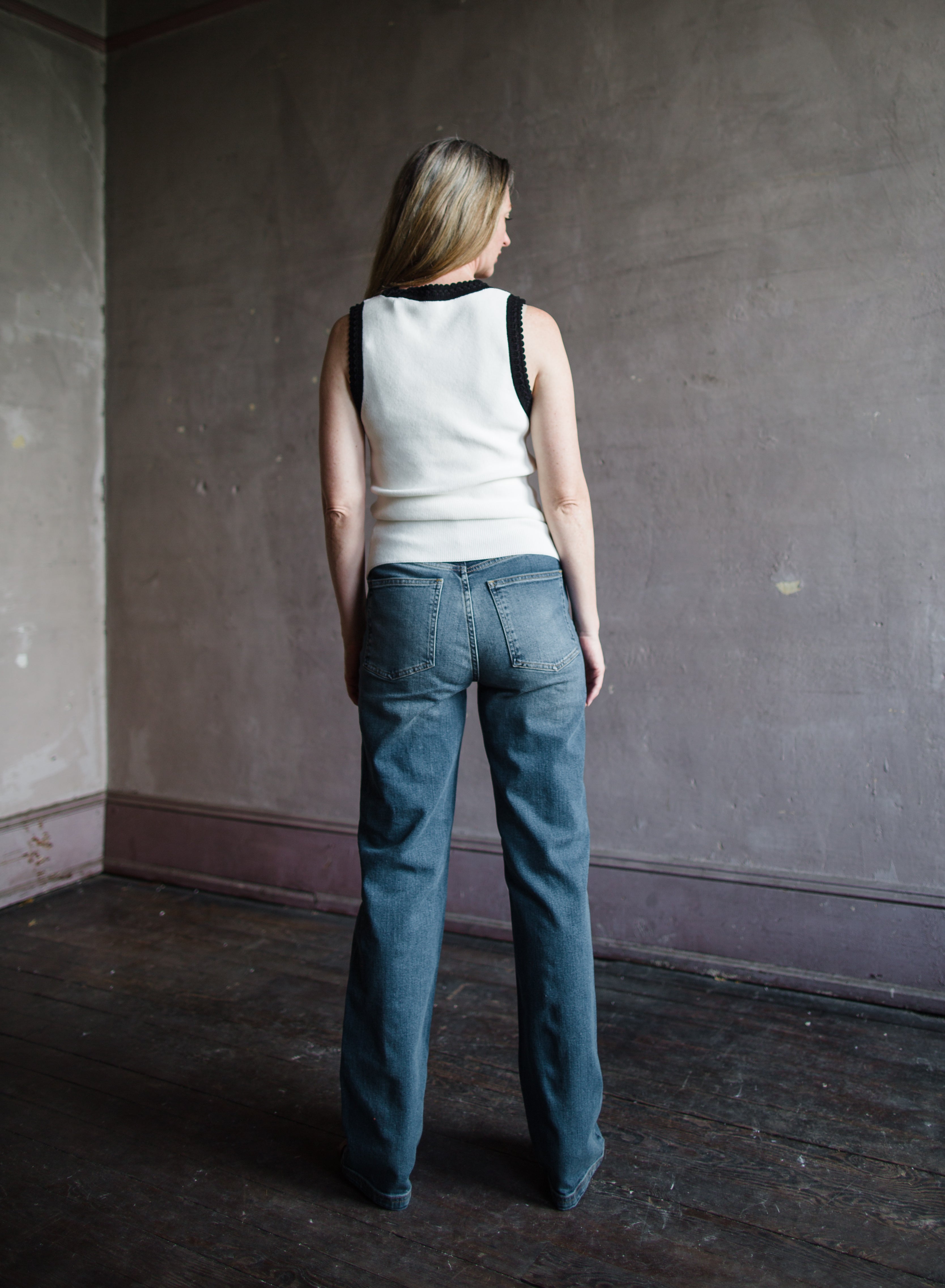 Mature woman wearing Vanessa Bruno Benito jeans with a zip fly, high rise, straight leg, full length medium wash