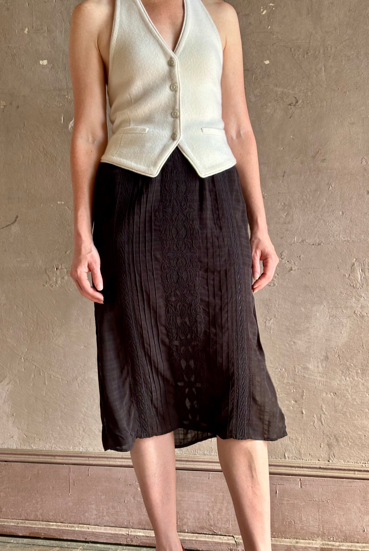 woman wearing Vanessa Bruno midi skirt semi-sheer jacquard black-on-black plaid delicate eyelet and pintucking