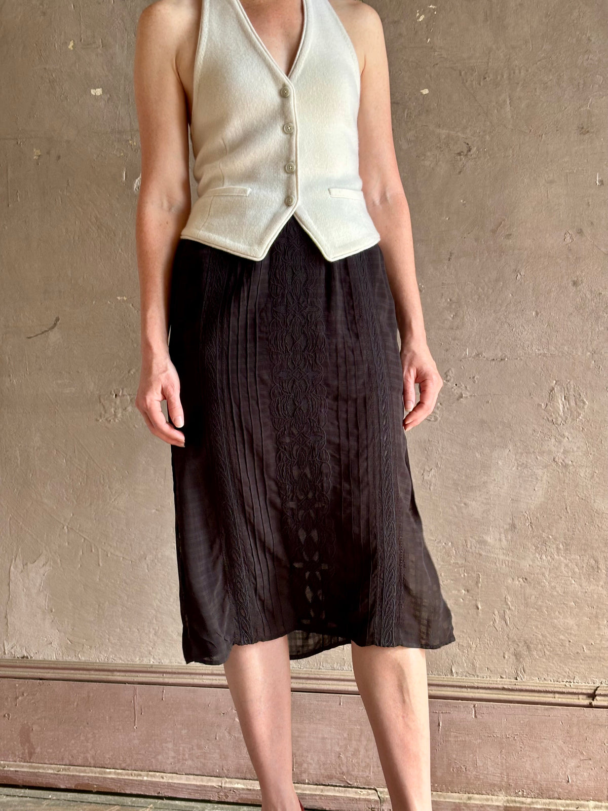 woman wearing Vanessa Bruno midi skirt semi-sheer jacquard black-on-black plaid delicate eyelet and pintucking