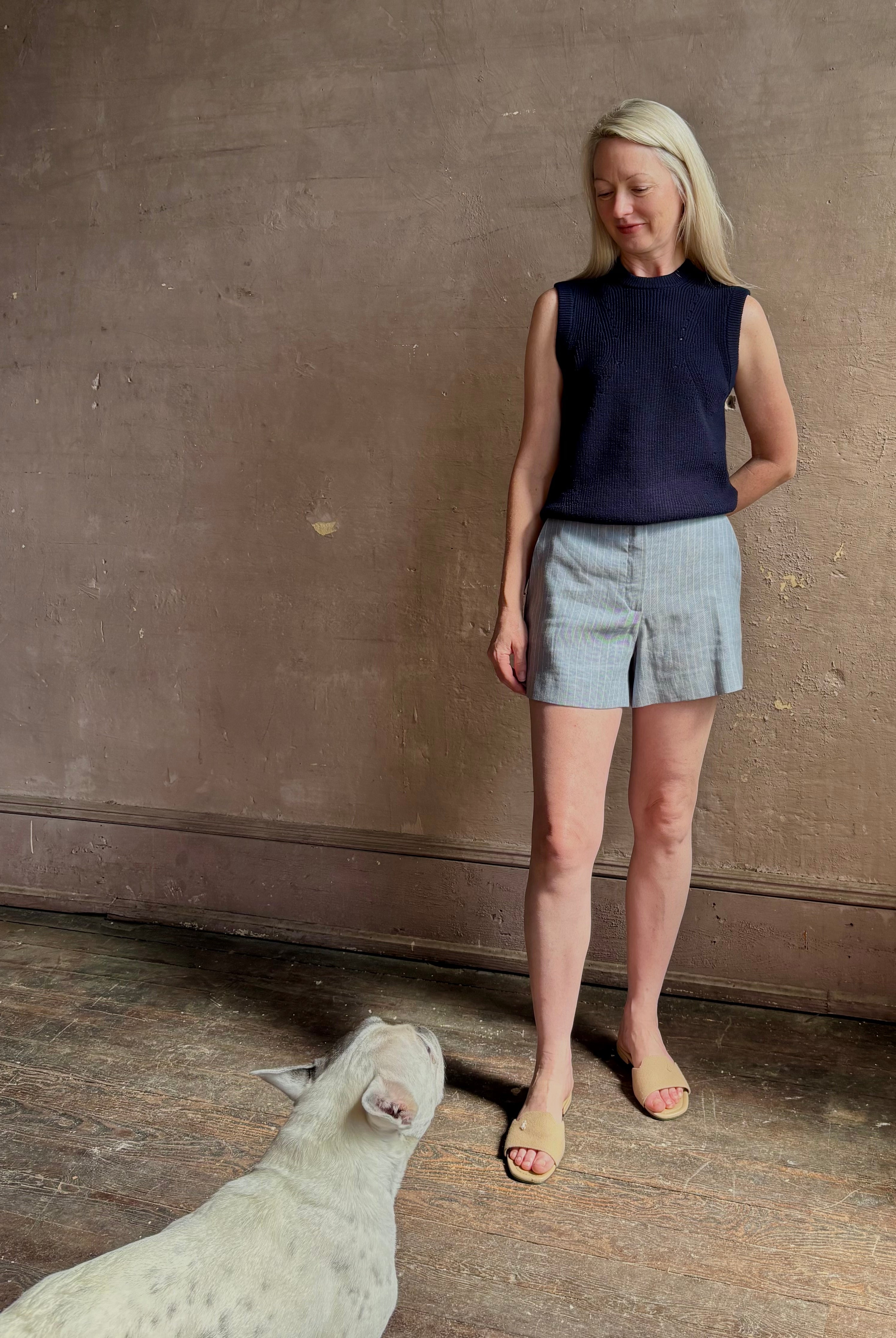 Woman wearing Vanessa Bruno Elisam elevated mid-rise tailored blue and white pinstripe short naturally breathable