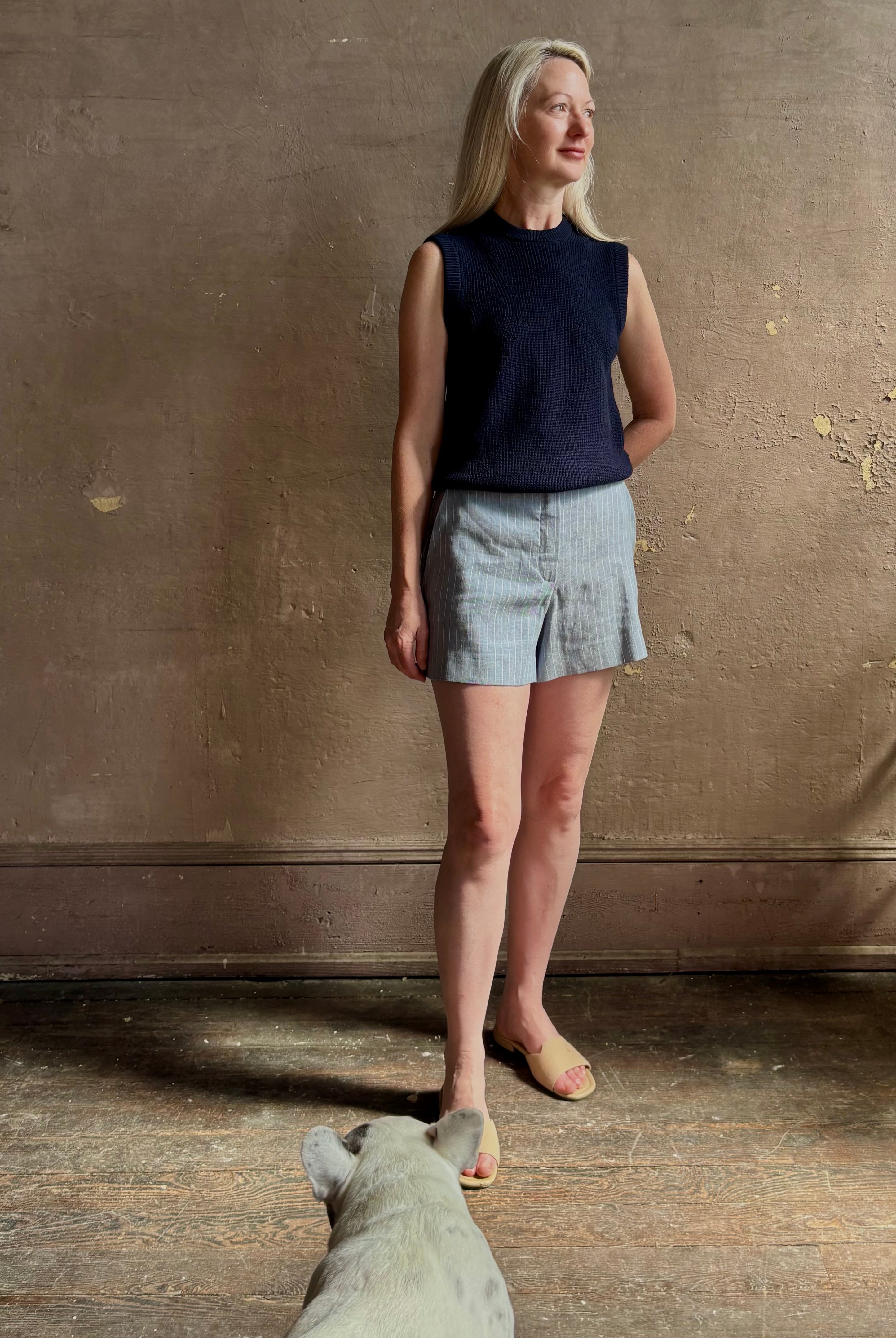 Woman wearing Vanessa Bruno Elisam elevated mid-rise tailored blue and white pinstripe short naturally breathable