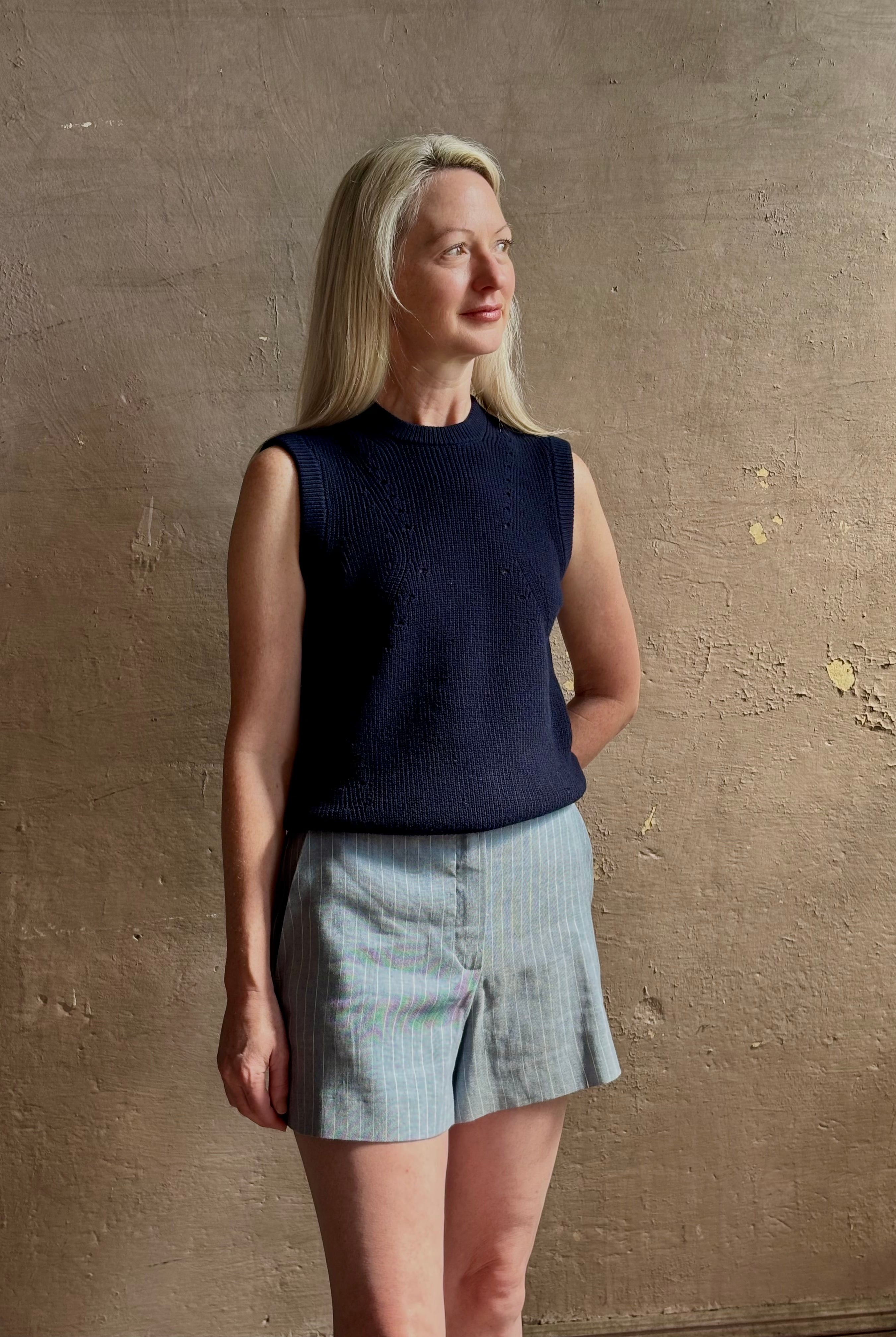 Woman wearing Vanessa Bruno Elisam elevated mid-rise tailored blue and white pinstripe short naturally breathable